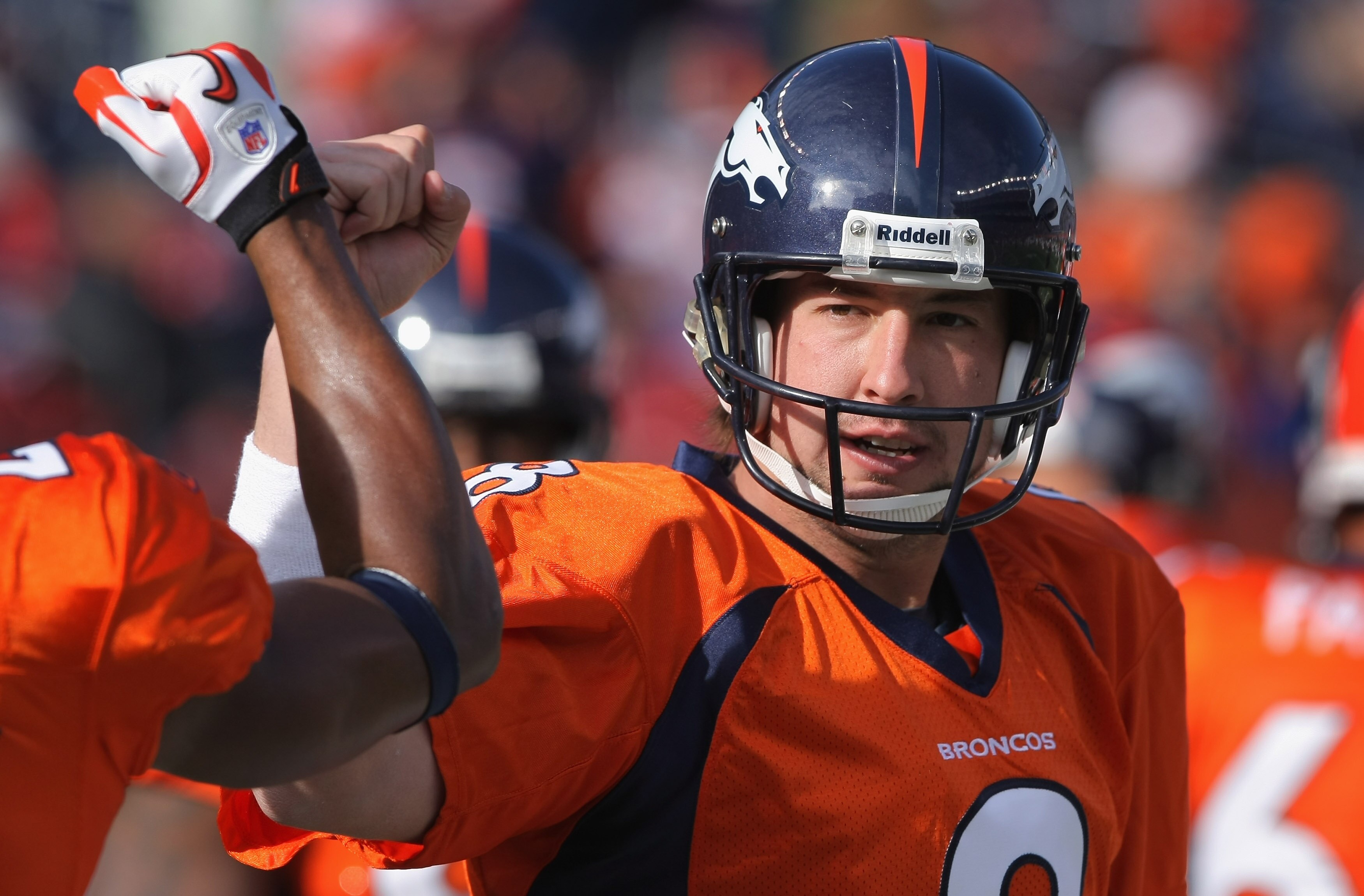 DENVER - NOVEMBER 14:  Quarterback Kyle Orton #8 of the Denver Broncos greets his teammates as they enter the field to face the Kansas City Chiefs at INVESCO Field at Mile High on November 14, 2010 in Denver, Colorado. The Broncos defeated the Chiefs 49-2