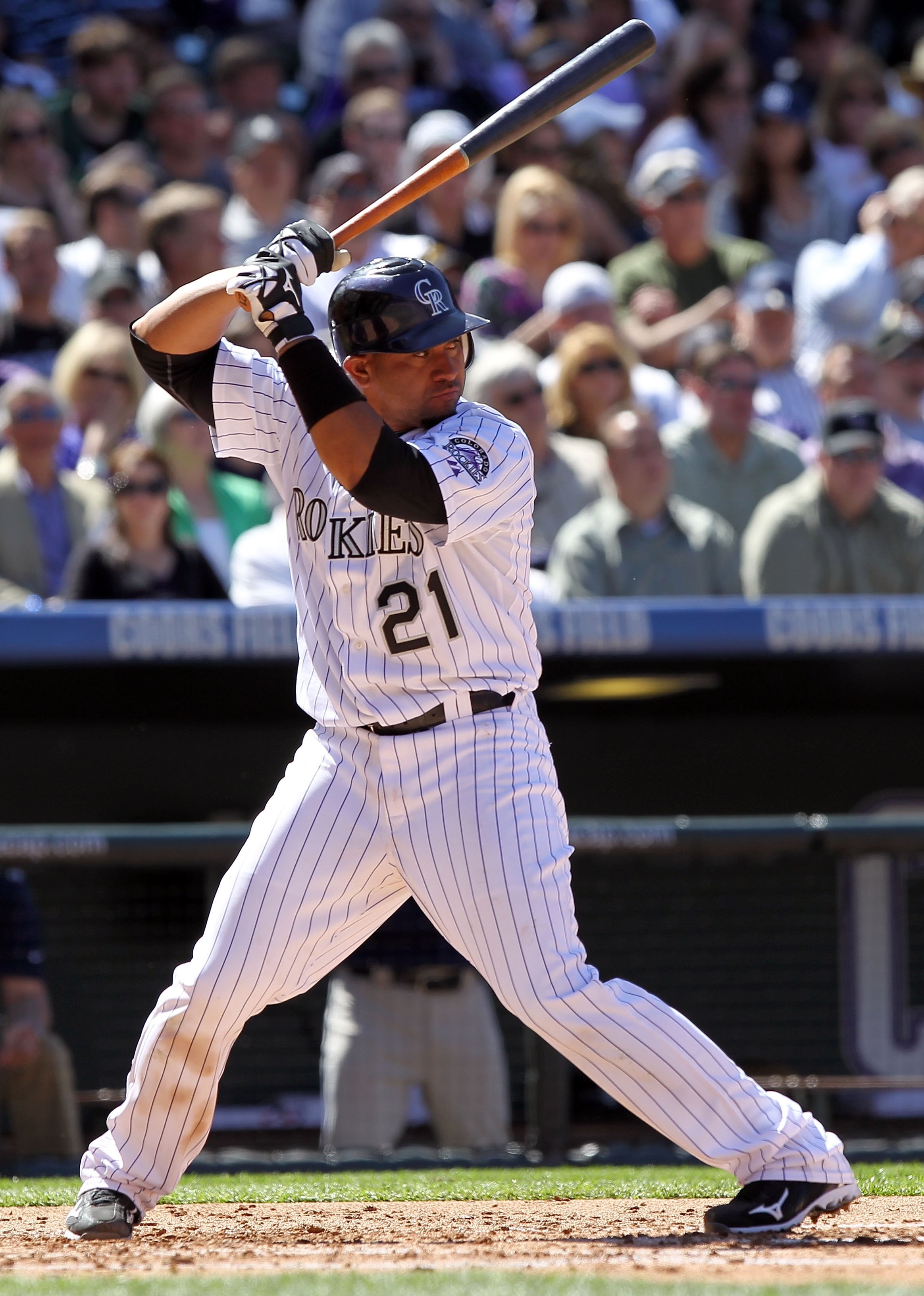 DENVER - APRIL 09:  Catcher Miguel Olivo #21 of the Colorado Rockies takes an at bat against the San Diego Padres during MLB action on Opening Day at Coors Field on April 9, 2010 in Denver, Colorado. The Rockies defeated the Padres 7-0.  (Photo by Doug Pe