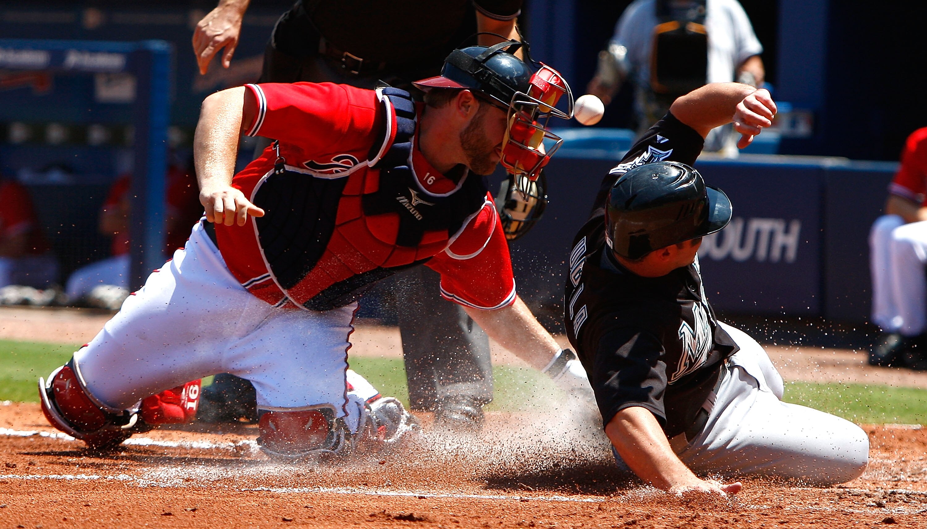 ATLANTA - AUGUST 23:  Catcher Brian McCann #16 of the Atlanta Braves loses the ball as Dan Uggla #6 of the Florida Marlins slides safely across homeplate on August 23, 2009 at Turner Field in Atlanta, Georgia.  (Photo by Kevin C. Cox/Getty Images)