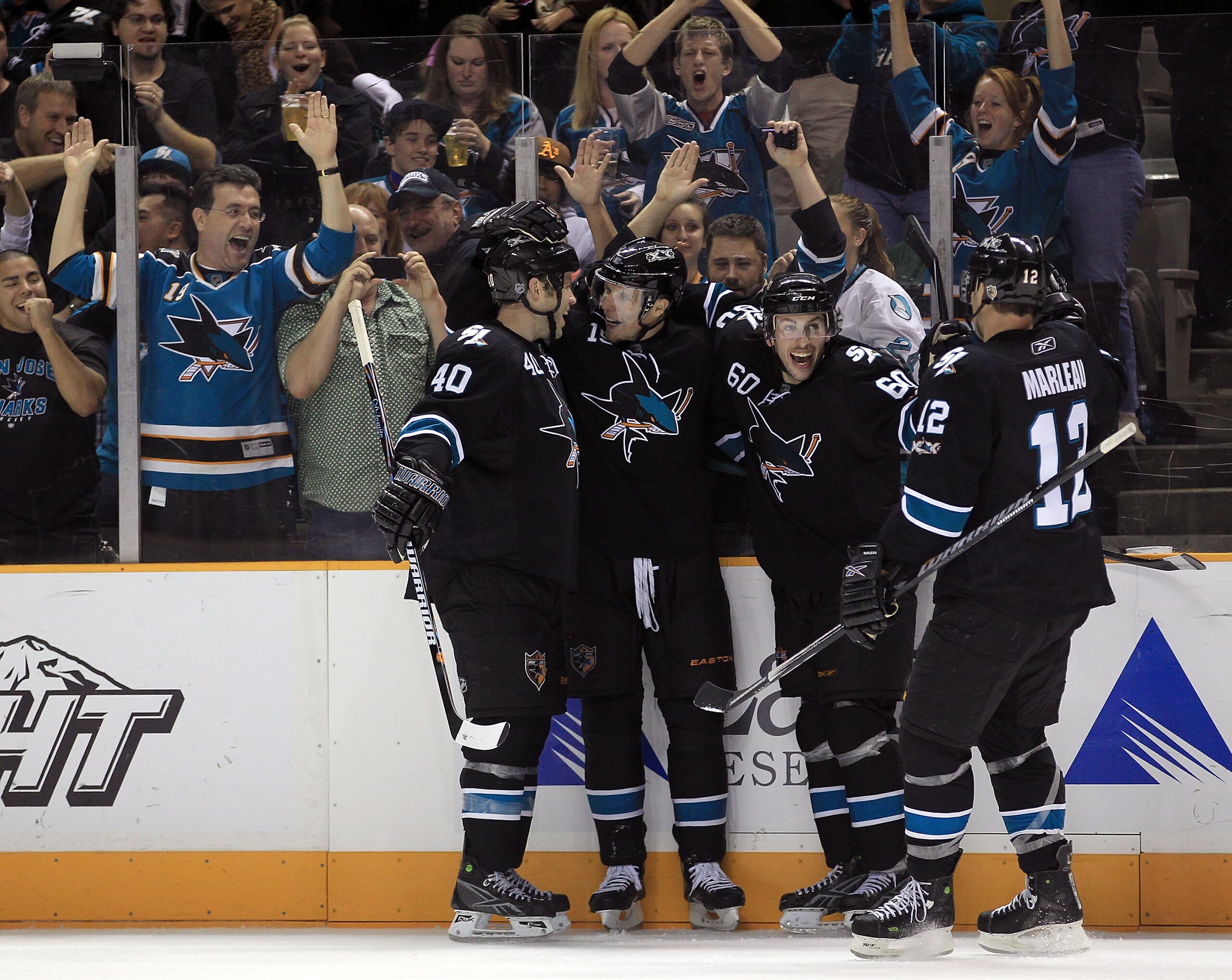 SAN JOSE, CA - NOVEMBER 15:  Dany Heatley #15 of the San Jose Sharks is congratulated by teammates Kent Huskins #40, Jason Demers #60 and Patrick Marleau #12  after he scored a goal during their game against the Los Angeles Kings at HP Pavilion on Novembe
