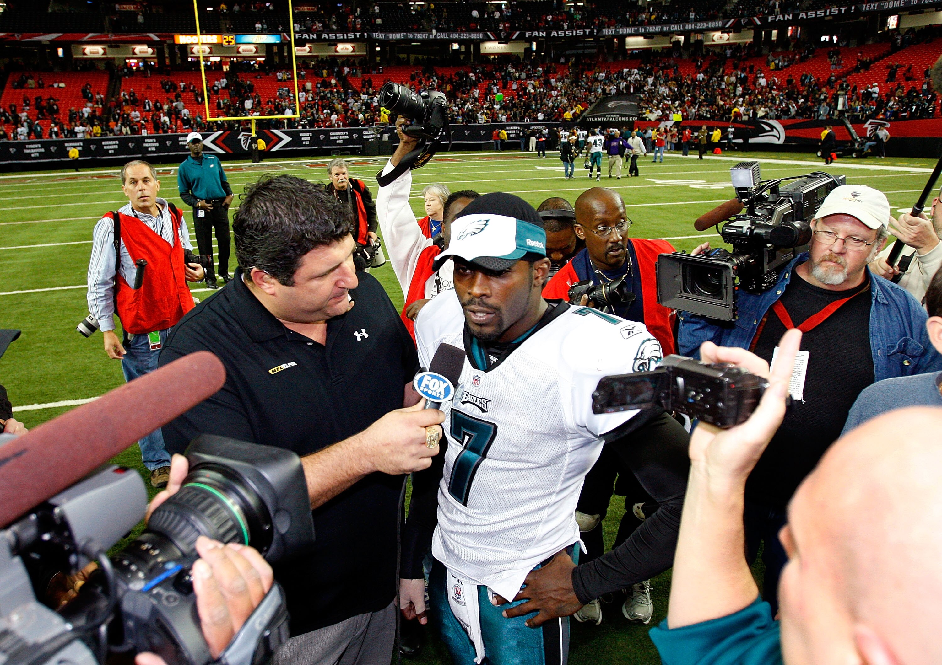 ATLANTA - DECEMBER 06:  Michael Vick #7 of the Philadelphia Eagles is interviewed by Fox Network sideline reporter Tony Siragusa (L) after their 34-7 win over the Atlanta Falcons at Georgia Dome on December 6, 2009 in Atlanta, Georgia.  (Photo by Kevin C.