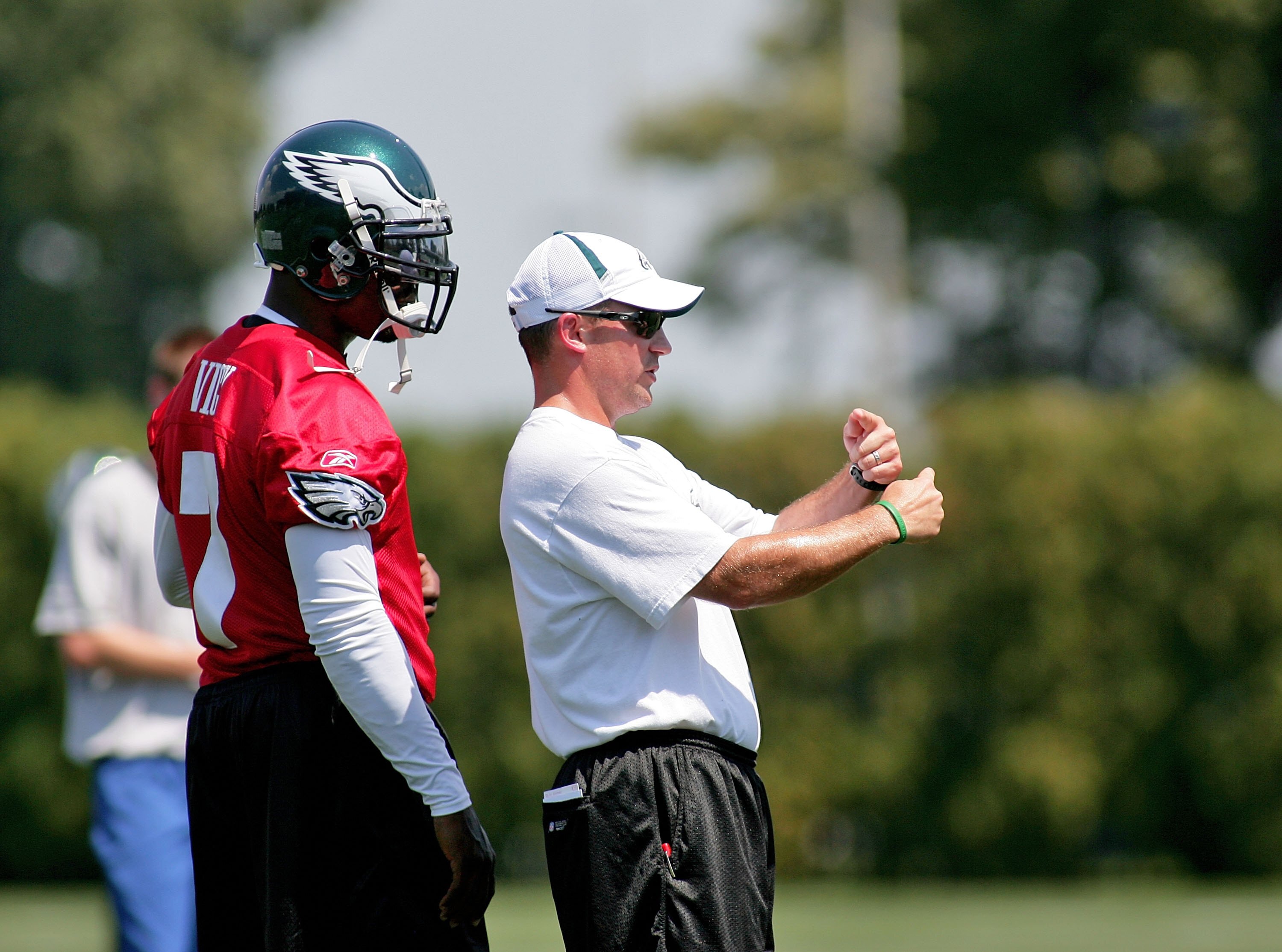 PHILADELPHIA - AUGUST 15:  Michael Vick #7 listens to Quarterbacks Coach James Urban in a workout at the NovaCare Complex on August 15, 2009 in Philadelphia, Pennsylvania.  (Photo by Len Redkoles/Getty Images)