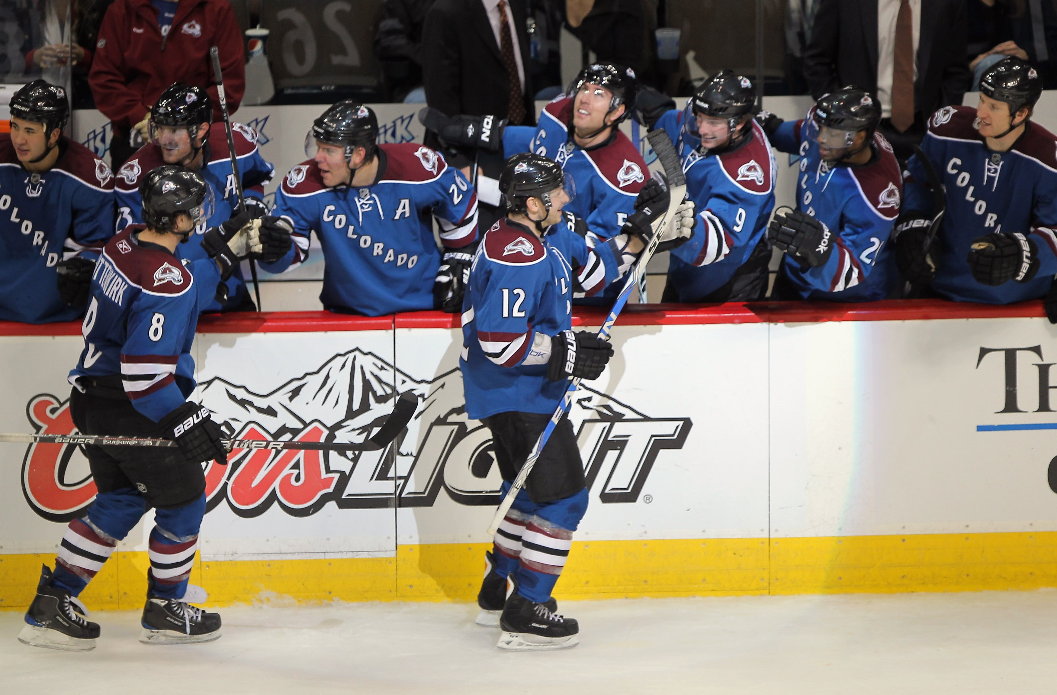 DENVER - NOVEMBER 15:  Kevin Porter #12 of the Colorado Avalanche is congratulated by his teammates for his third period goal of the St. Louis Blues along with Kevin Shattenkirk #8 at the Pepsi Center on November 15, 2010 in Denver, Colorado. The Avalanch