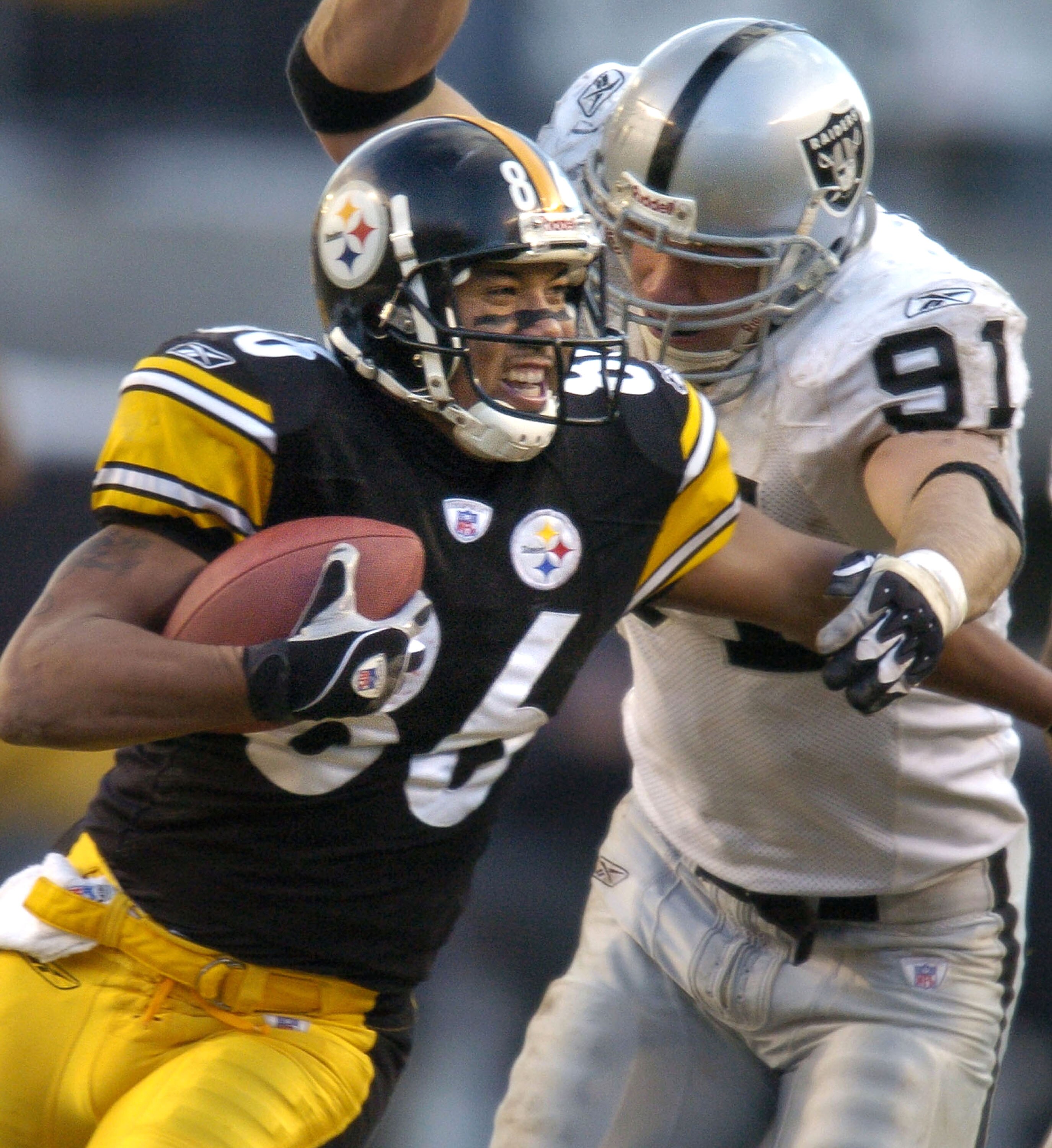 PITTSBURGH - DECEMBER 7:  Hines Ward #86 of the Pittsburgh Steelers is chased by Tyler Brayton #91 of the Oakland Raiders during the third quarter on December 7, 2003 at Heinz Field in Pittsburgh, Pennsylvania. The Steelers defeated the Raiders 27-7.  (Ph