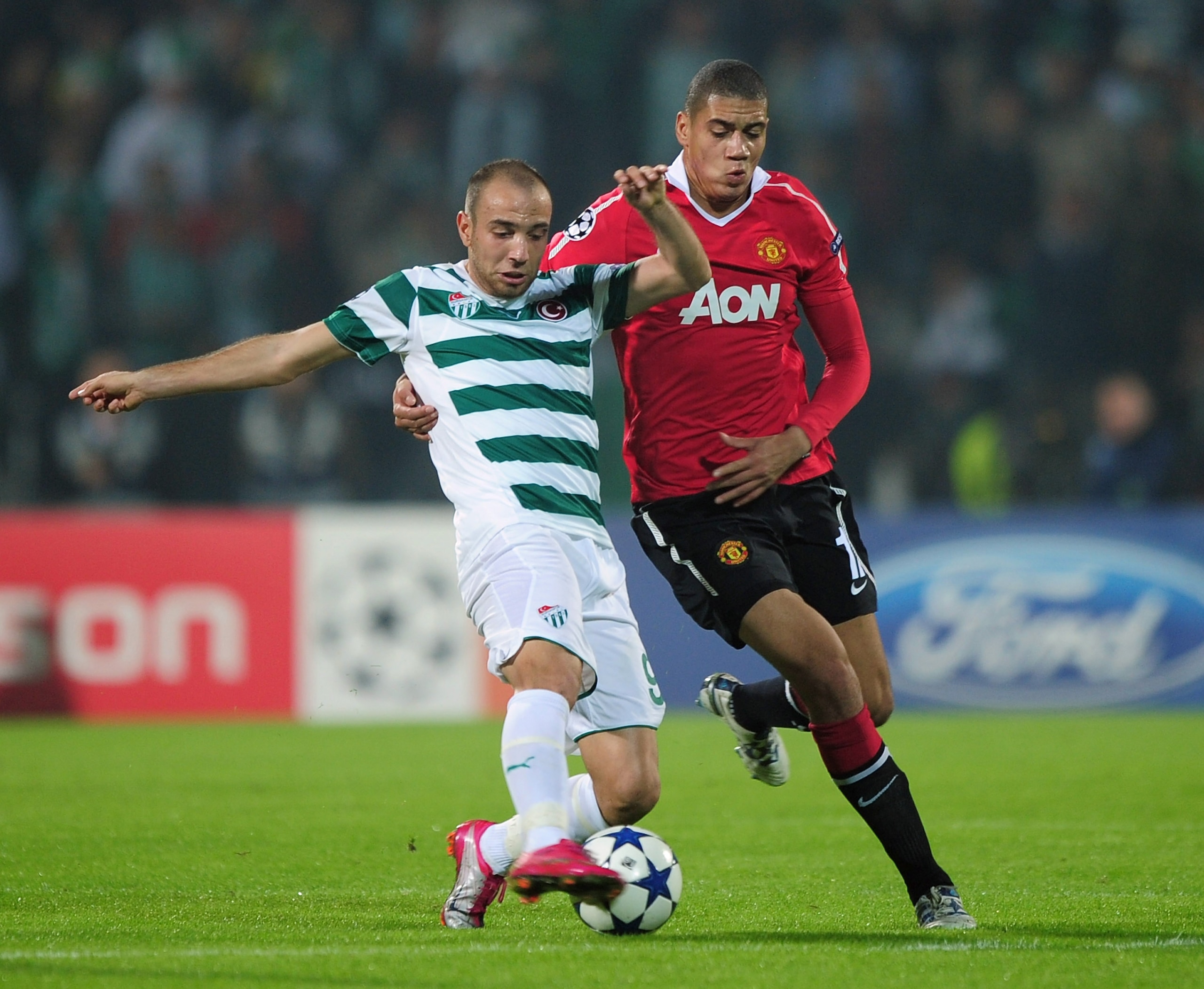 BURSA, TURKEY - NOVEMBER 02: Sercan Yildirim of Bursaspor Kulubu is challenged by Chris Smalling of Manchester United during the UEFA Champions League Group C match between Bursapor Kulubu and Manchester United at the Bursa Ataturk Stadium on November 2, BURSA, TURKEY - NOVEMBER 02: Sercan Yildirim of Bursaspor Kulubu is challenged by Chris Smalling of Manchester United during the UEFA Champions League Group C match between Bursapor Kulubu and Manchester United at the Bursa Ataturk Stadium on November 2,
