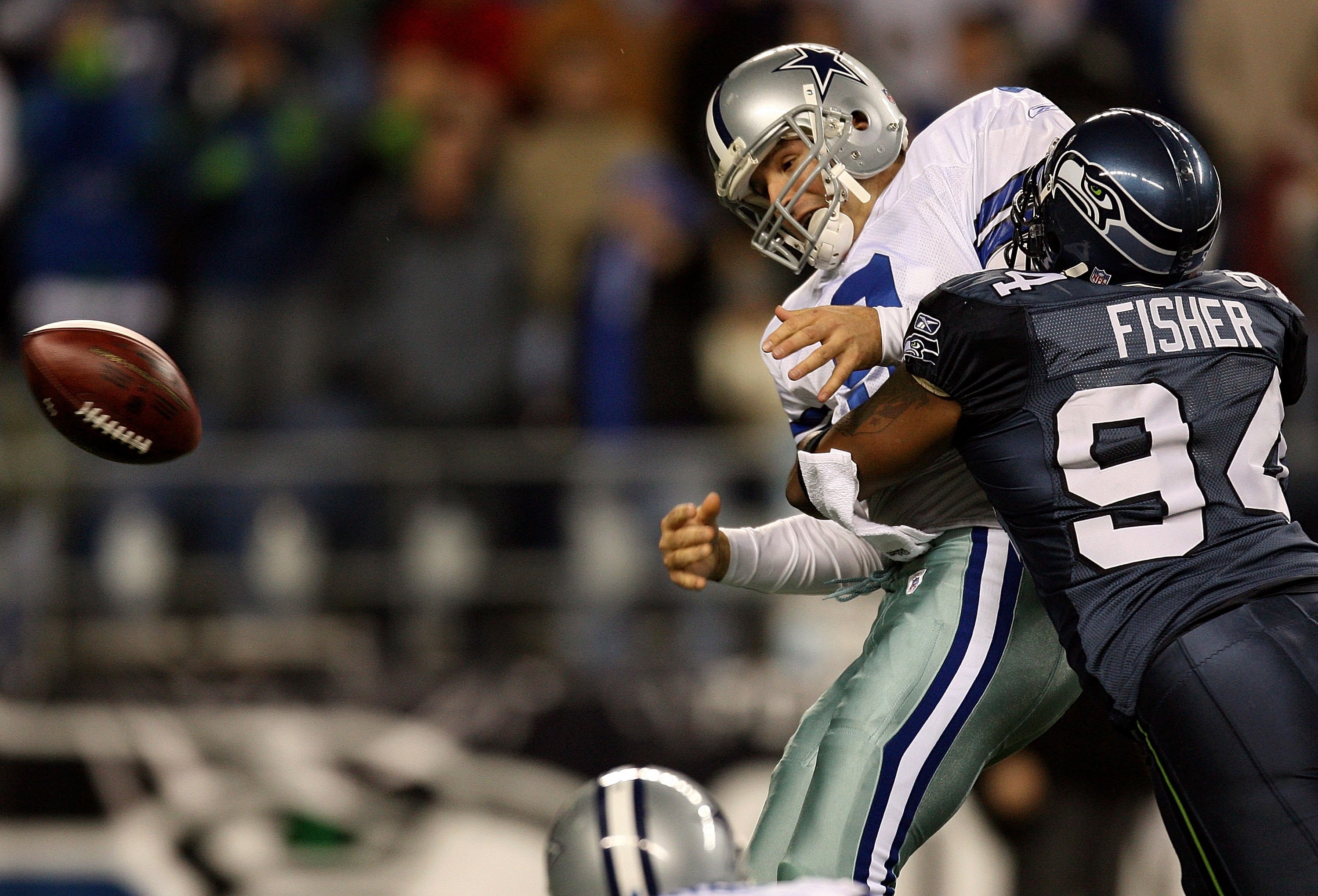 SEATTLE - JANUARY 06:  Quarterback Tony Romo #9 of the Dallas Cowboys is taken down by Bryce Fisher #94 of the Seattle Seahawks near the Cowboys goal line in the second half of the NFC Wild Card Playoff Game on January 6, 2007 at Qwest Field in Seattle, W