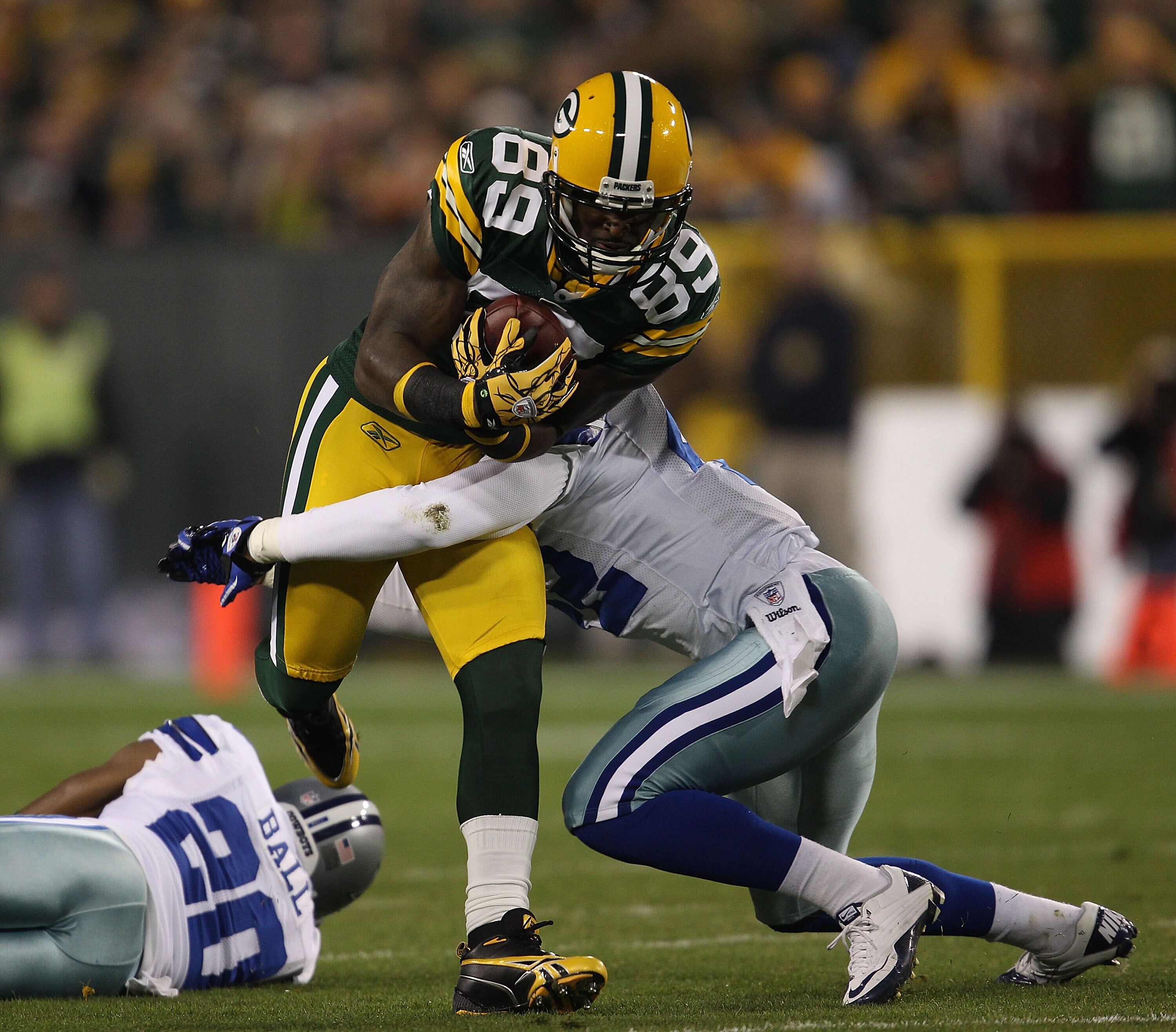 GREEN BAY, WI - NOVEMBER 07: James Jones #89 of the Green Bay Packers runs past Alan Ball #20 of the Dallas Cowboys as Barry Church #42 moves in for the tackle at Lambeau Field on November 7, 2010 in Green Bay, Wisconsin. The Packers defeated the Cowboys GREEN BAY, WI - NOVEMBER 07: James Jones #89 of the Green Bay Packers runs past Alan Ball #20 of the Dallas Cowboys as Barry Church #42 moves in for the tackle at Lambeau Field on November 7, 2010 in Green Bay, Wisconsin. The Packers defeated the Cowboys