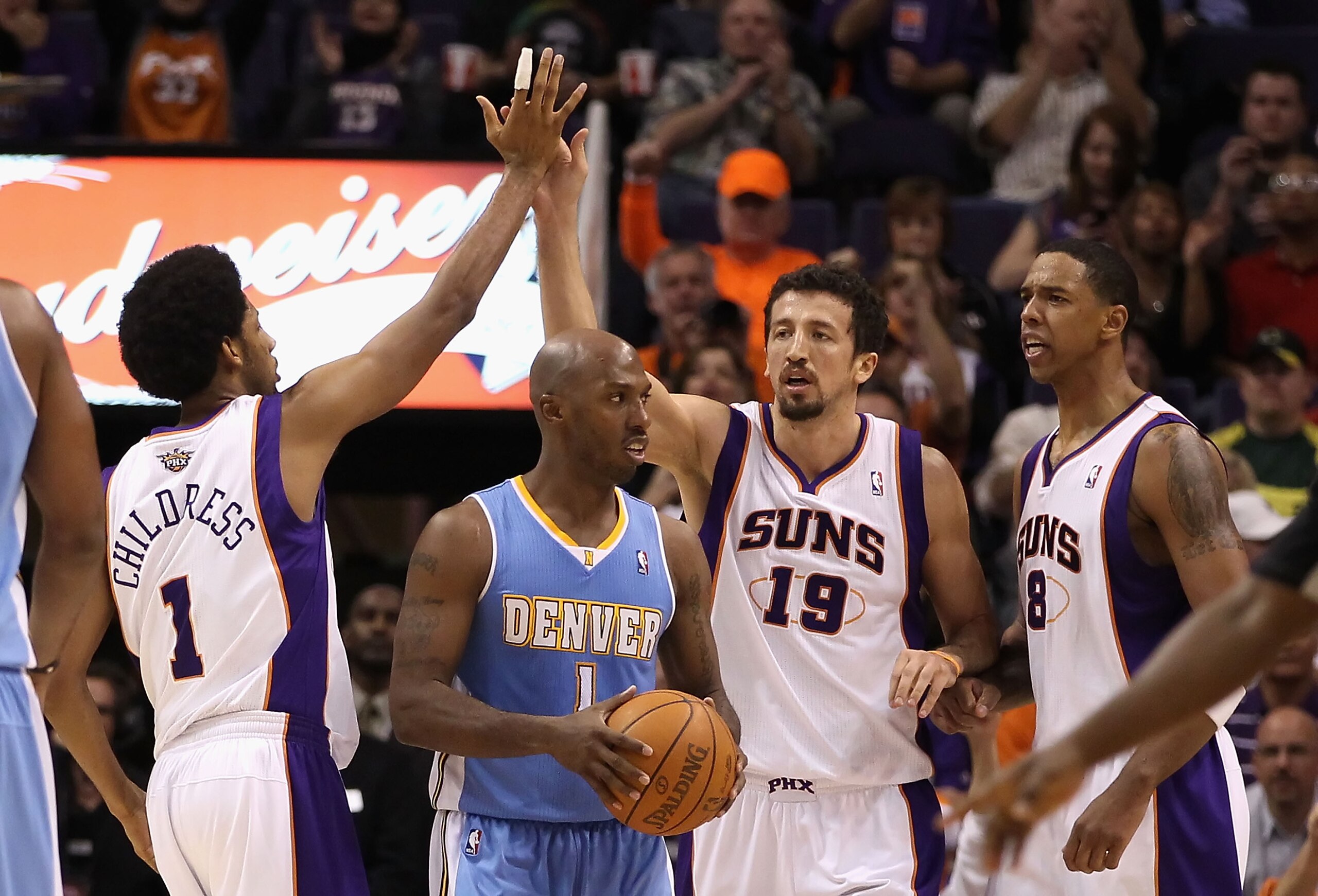 PHOENIX - NOVEMBER 15:  Hedo Turkoglu #19 of the Phoenix Suns high fives teammate Josh Childress #1 after scoring and drawing a foul against the Denver Nuggets during the NBA game at US Airways Center on November 15, 2010 in Phoenix, Arizona. The Suns def