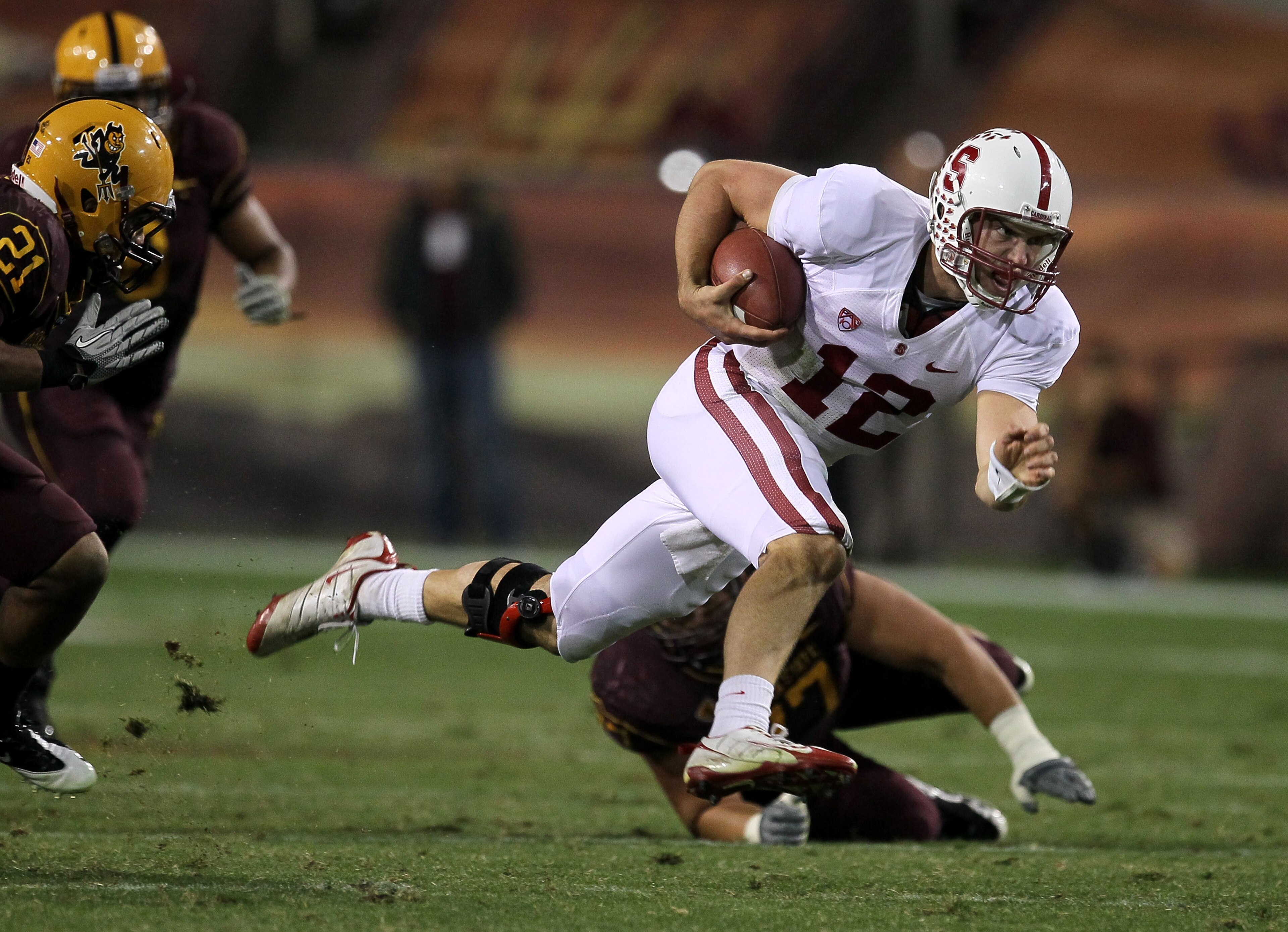 TEMPE, AZ - NOVEMBER 13:  Quarterback Andrew Luck #12 of the Stanford Cardinal scrambles for a first down against the Arizona State Sun Devils at Sun Devil Stadium on November 13, 2010 in Tempe, Arizona.The Cardinal won 17-13.  (Photo by Stephen Dunn/Gett