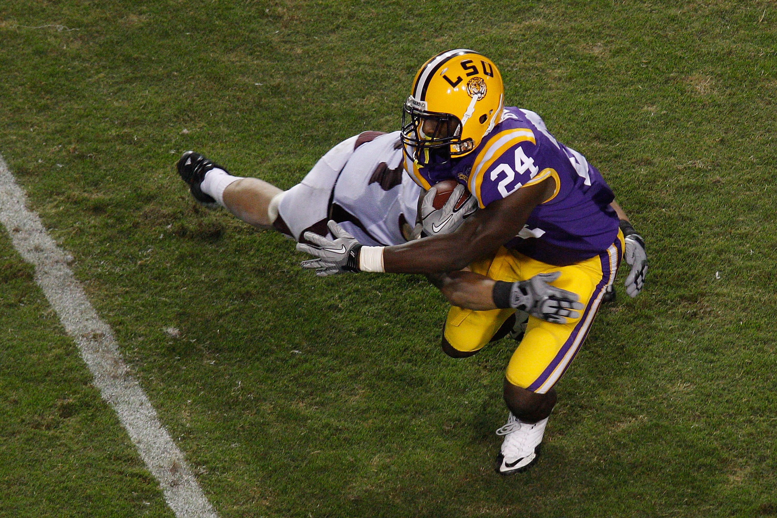 BATON ROUGE, LA - NOVEMBER 13:  Alfred Blue #24 of the Louisiana State University Tigers is tackled by Ty Kittle #87 of the University of Louisiana-Monroe Warhawks at Tiger Stadium on November 13, 2010 in Baton Rouge, Louisiana.   The Tigers defeated the