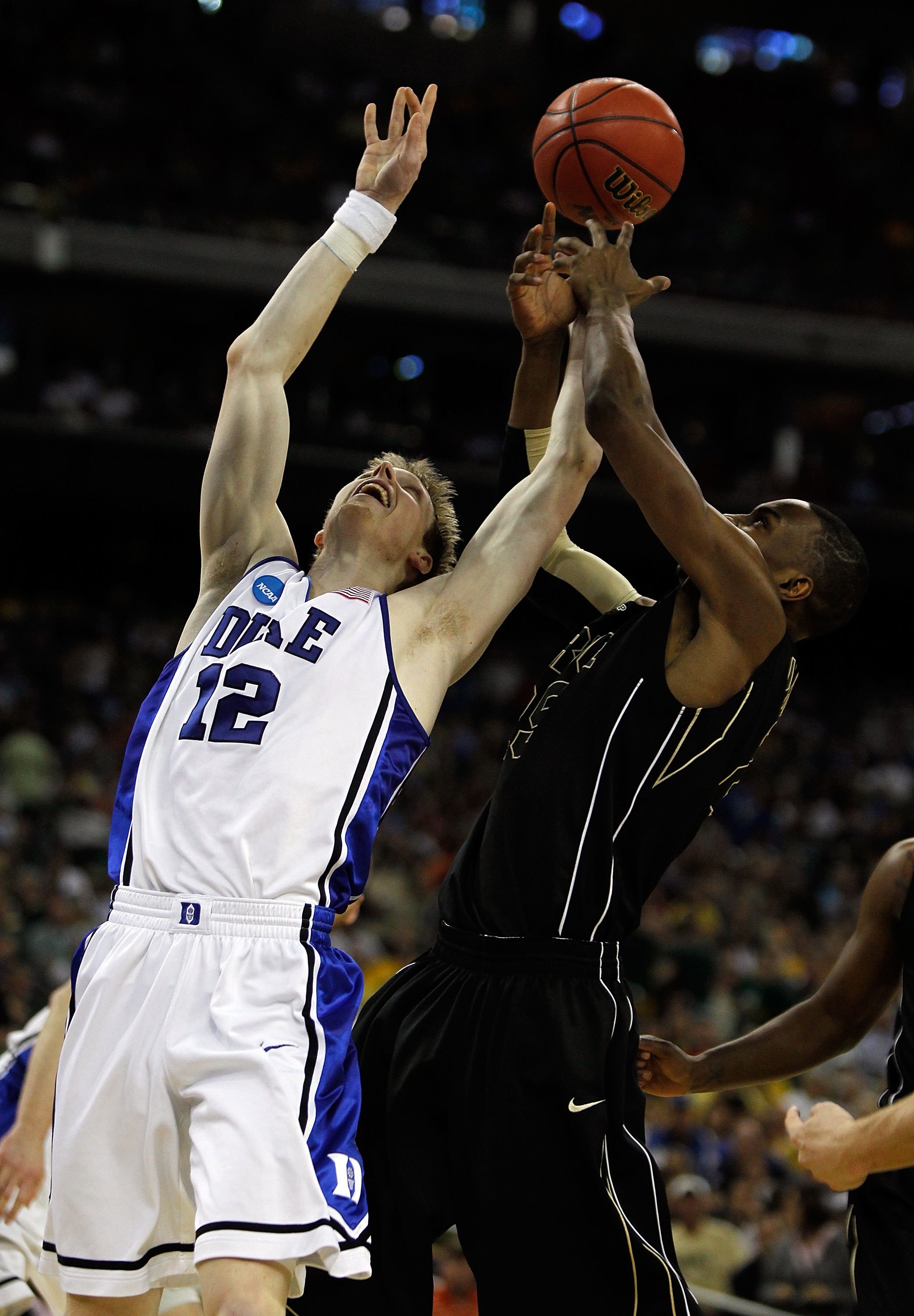HOUSTON - MARCH 26: Kyle Singler #12 of the Duke Blue Devils battles for a rebound with JaJuan Johnson #25 of the Purdue Boilermakers during the south regional semifinal of the 2010 NCAA men's basketball tournament at Reliant Stadium on March 26, 2010 in HOUSTON - MARCH 26: Kyle Singler #12 of the Duke Blue Devils battles for a rebound with JaJuan Johnson #25 of the Purdue Boilermakers during the south regional semifinal of the 2010 NCAA men's basketball tournament at Reliant Stadium on March 26, 2010 in