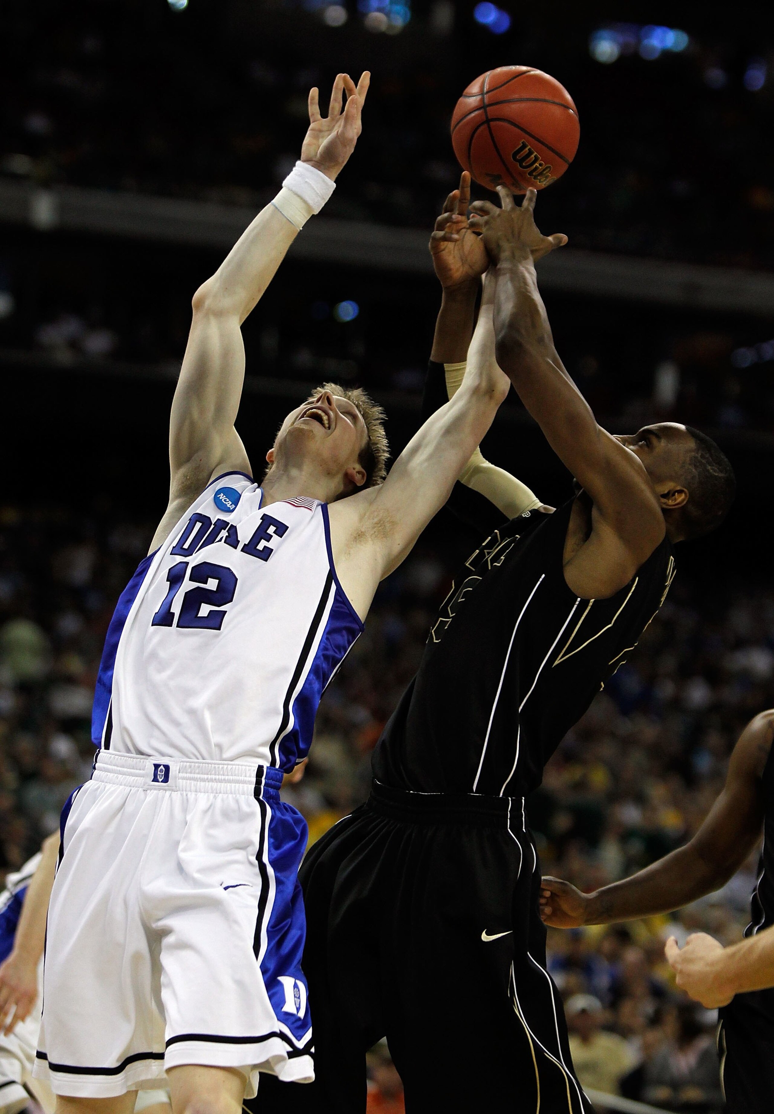 HOUSTON - MARCH 26: Kyle Singler #12 of the Duke Blue Devils battles for a rebound with JaJuan Johnson #25 of the Purdue Boilermakers during the south regional semifinal of the 2010 NCAA men's basketball tournament at Reliant Stadium on March 26, 2010 in