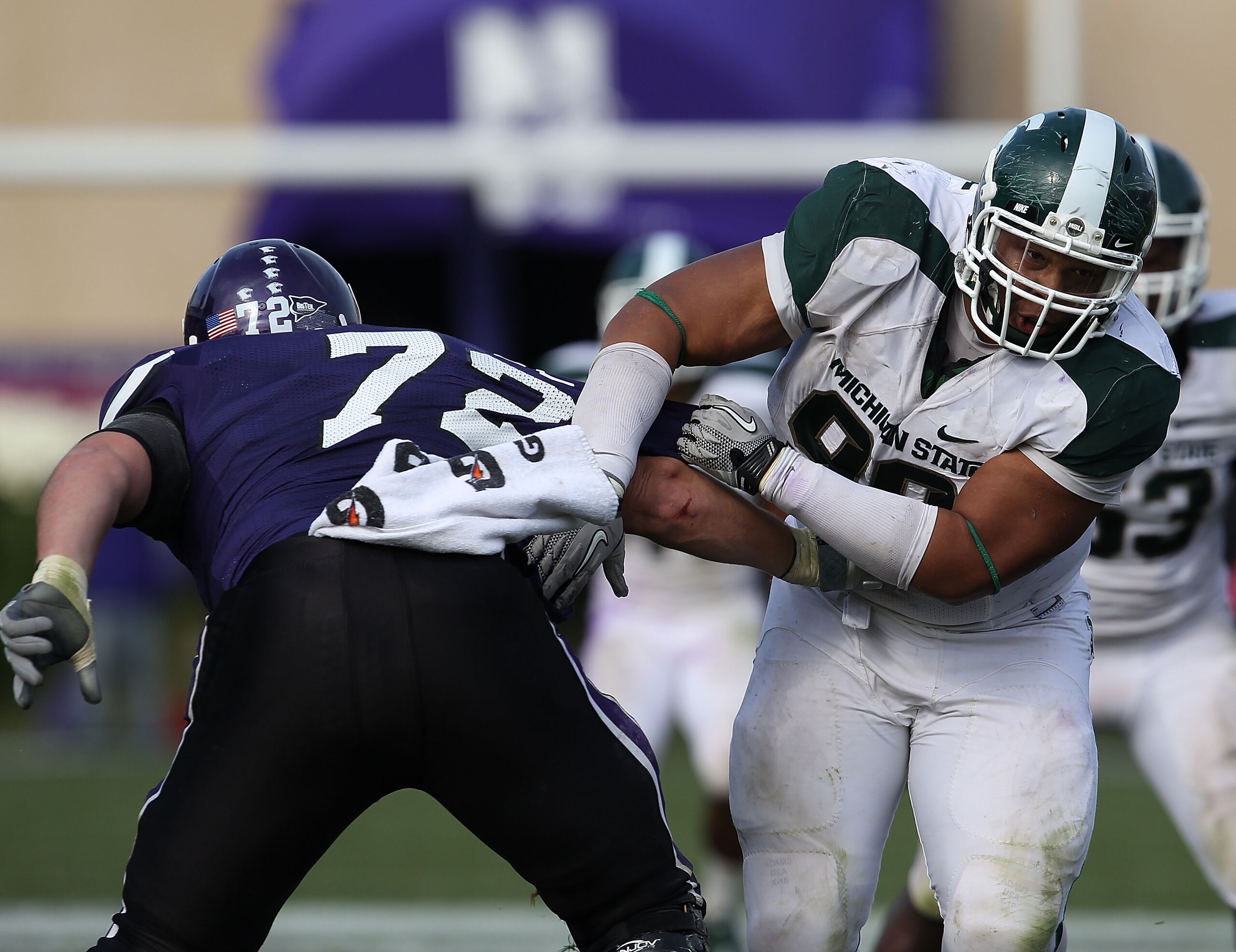EVANSTON, IL - OCTOBER 23: Jerel Worthy #99 of the Michigan State Spartans moves past a block attempt by Brian Mulroe #72 of the Northwestern Wildcats at Ryan Field on October 23, 2010 in Evanston, Illinois. Michigan State defeated Northwestern 35-27. (Ph