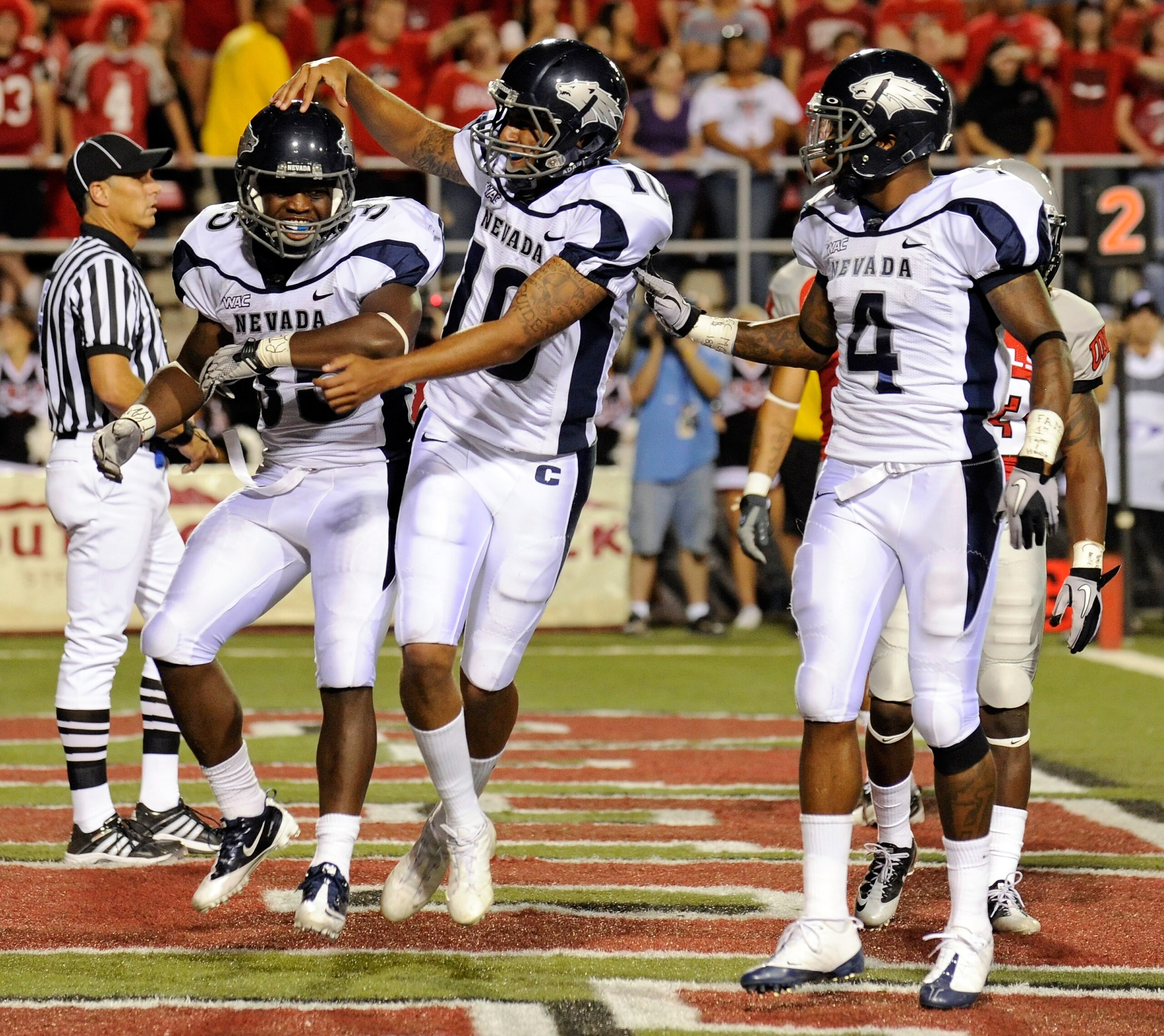 LAS VEGAS - OCTOBER 02: (L-R) Courtney Randall #35 of the Nevada Reno Wolf Pack is congratulated by quarterback Colin Kaepernick #10 and Brandon Wimberly #4 after Randall scored a touchdown against the UNLV Rebels in the second quarter of their game at S LAS VEGAS - OCTOBER 02: (L-R) Courtney Randall #35 of the Nevada Reno Wolf Pack is congratulated by quarterback Colin Kaepernick #10 and Brandon Wimberly #4 after Randall scored a touchdown against the UNLV Rebels in the second quarter of their game at S