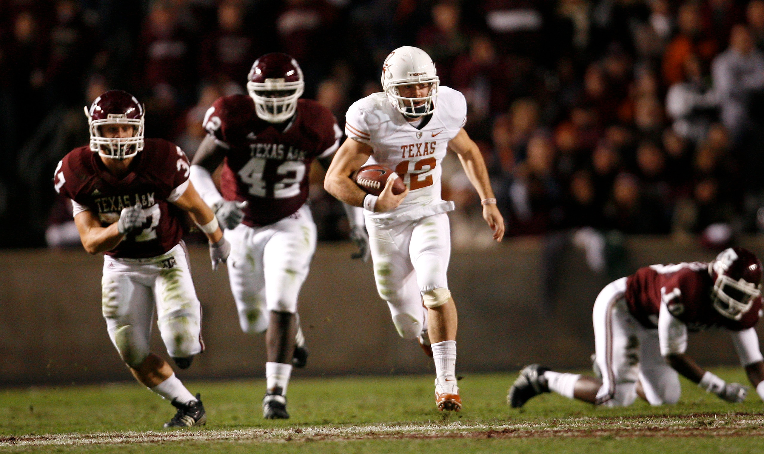 COLLEGE STATION, TX - NOVEMBER 26: Quarterback Colt McCoy #12 of the Texas Longhorns scrambles away from the Texas A&M Aggies defense to score a touchdown in the first half at Kyle Field on November 26, 2009 in College Station, Texas. (Photo by Aaron M. COLLEGE STATION, TX - NOVEMBER 26: Quarterback Colt McCoy #12 of the Texas Longhorns scrambles away from the Texas A&M Aggies defense to score a touchdown in the first half at Kyle Field on November 26, 2009 in College Station, Texas. (Photo by Aaron M.