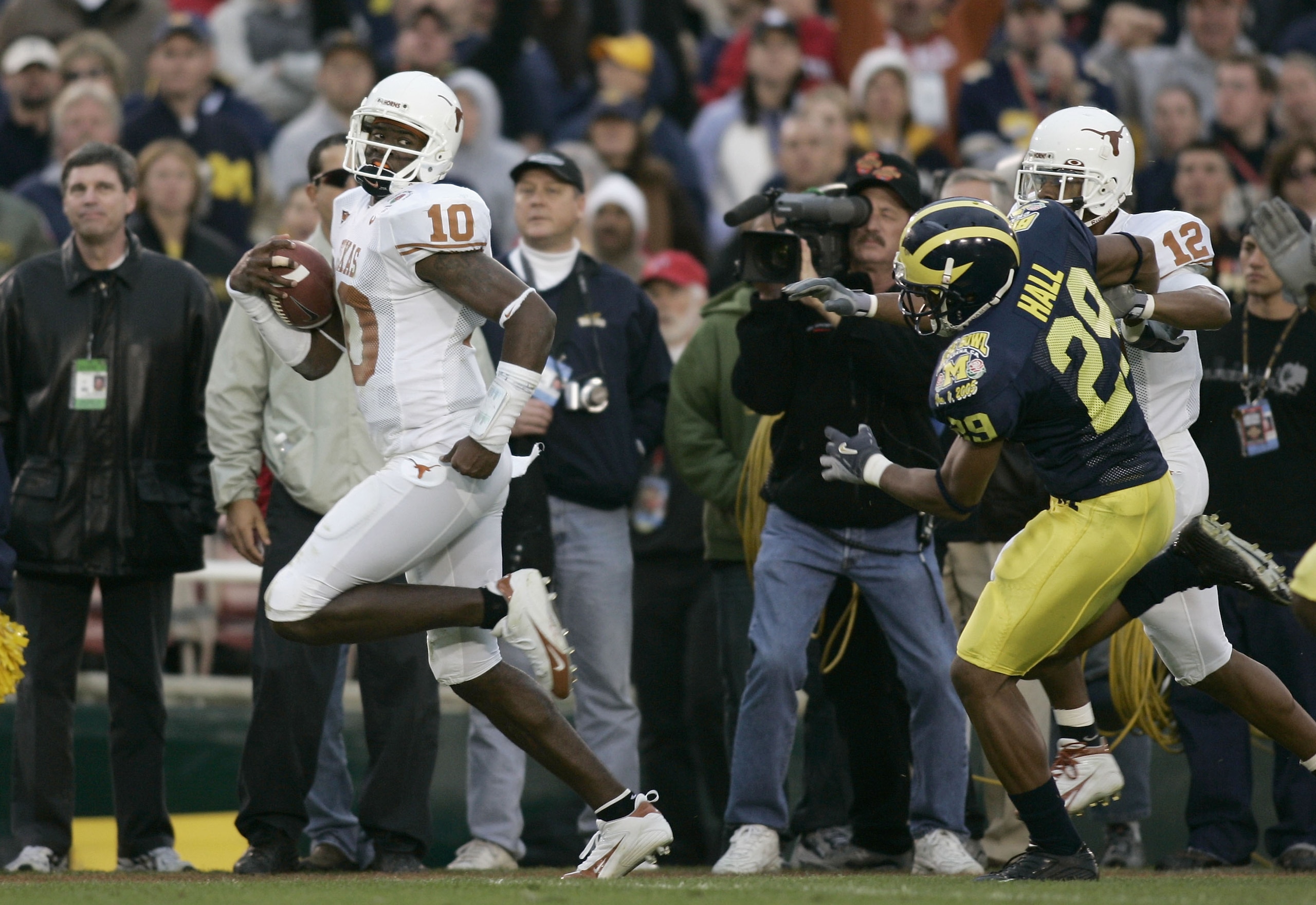 PASADENA, CA - JANUARY 01: Quarterback Vince Young #10 of the Texas Longhorns scores his second rushing touchdown past Leon Hall #29 of the Michigan Wolverines in the 91st Rose Bowl Game at the Rose Bowl on January 1, 2005 in Pasadena, California. (Ph PASADENA, CA - JANUARY 01: Quarterback Vince Young #10 of the Texas Longhorns scores his second rushing touchdown past Leon Hall #29 of the Michigan Wolverines in the 91st Rose Bowl Game at the Rose Bowl on January 1, 2005 in Pasadena, California. (Ph