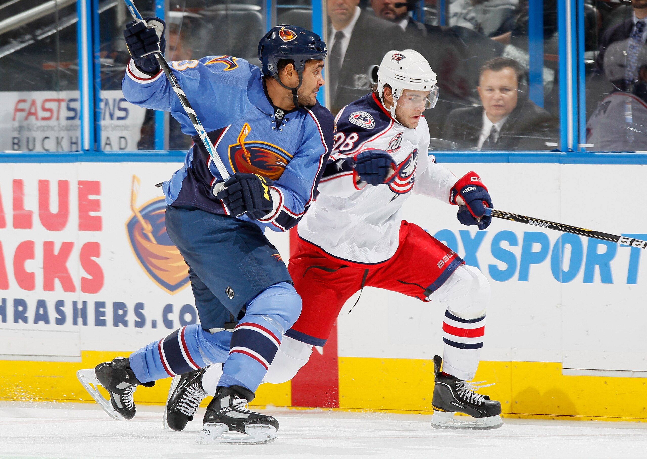 ATLANTA - NOVEMBER 04:  Dustin Byfuglien #33 of the Atlanta Thrashers prepares to check Nikita Filatov #28 of the Columbus Blue Jackets into the boards at Philips Arena on November 4, 2010 in Atlanta, Georgia.  (Photo by Kevin C. Cox/Getty Images)