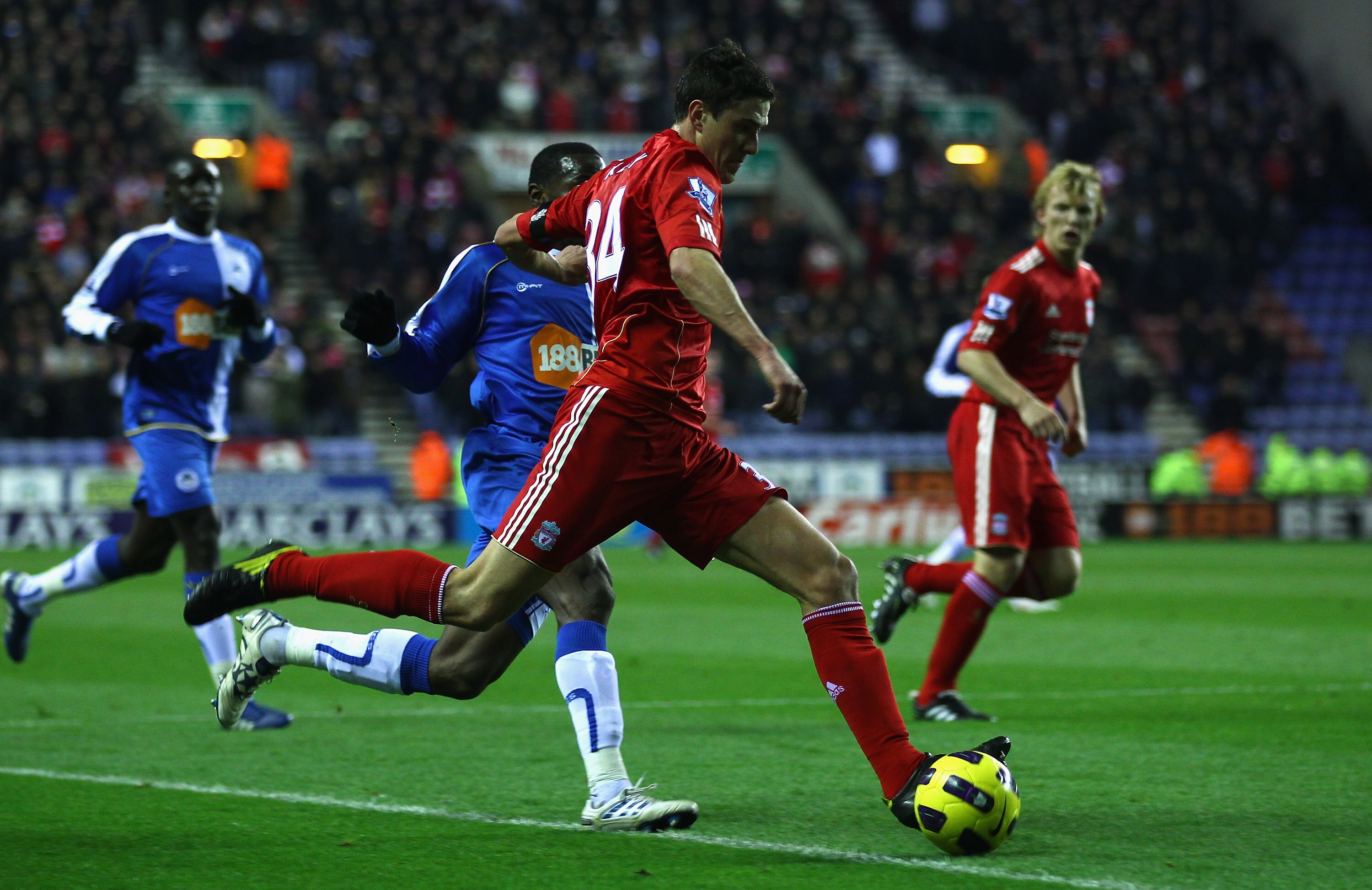 WIGAN, ENGLAND - NOVEMBER 10: Martin Kelly of Liverpool attempts to cross the ball during the Barclays Premier League match between Wigan Athletic and Liverpool at DW Stadium on November 10, 2010 in Wigan, England.  (Photo by Clive Brunskill/Getty Images)