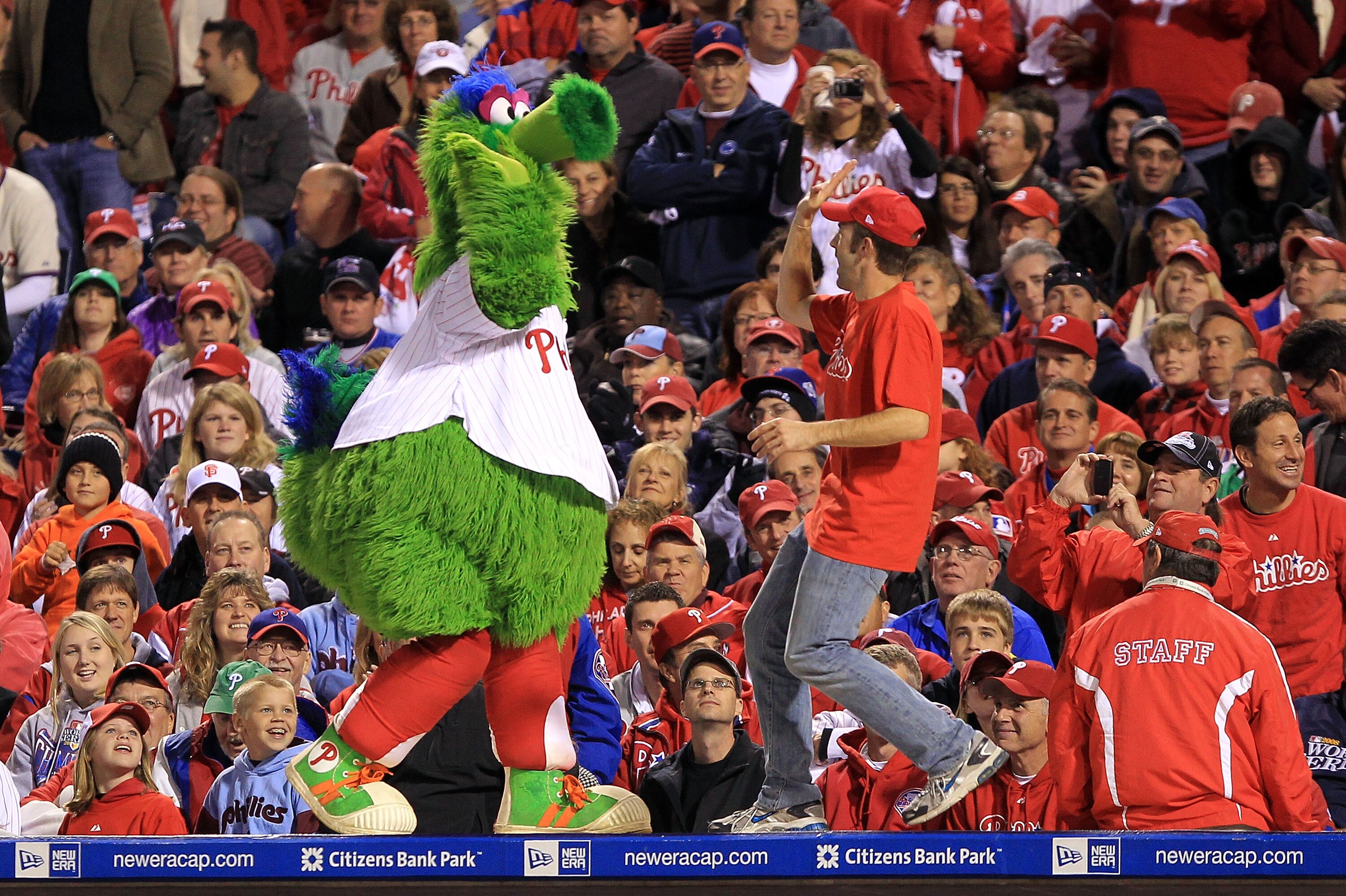 PHILADELPHIA - OCTOBER 16:  The Phillie Phanatic performs with a male performer during Game One of the NLCS during the 2010 MLB Playoffs between the Philadelphia Phillies and the San Francisco Giants at Citizens Bank Park on October 16, 2010 in Philadelph