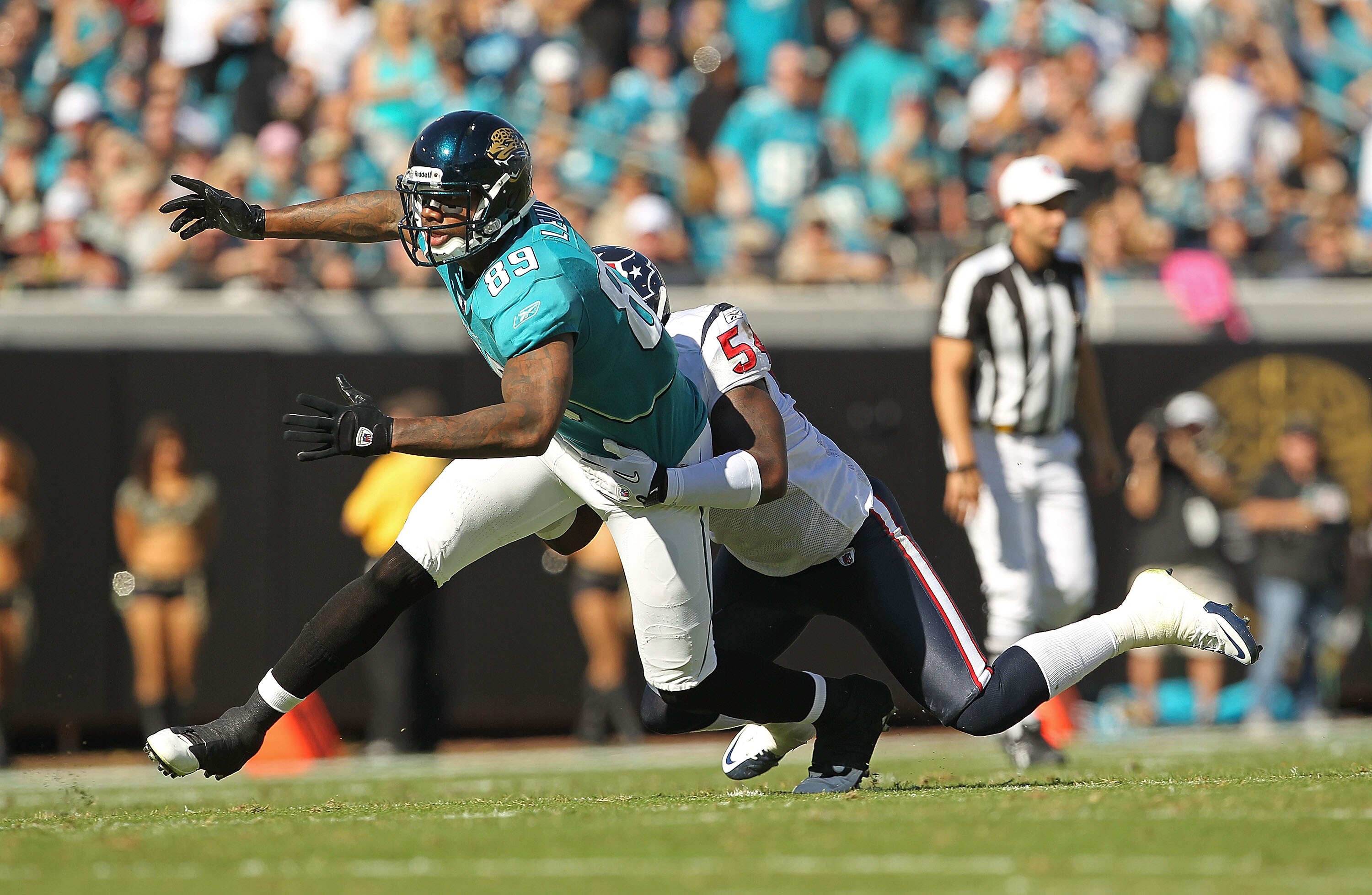 JACKSONVILLE, FL - NOVEMBER 14:  Mercedes Lewis #89 of the Jacksonville Jaguars misses a catch before being tackled by Zac Diles #54 during a game against the Houston Texans at EverBank Field on November 14, 2010 in Jacksonville, Florida.  (Photo by Mike