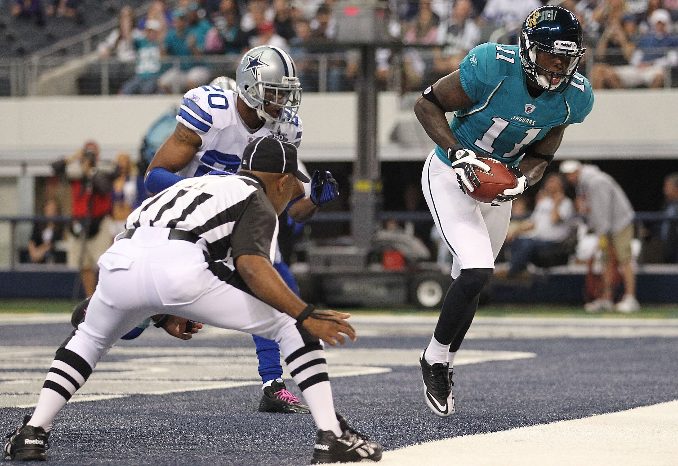 ARLINGTON, TX - OCTOBER 31:  Wide receiver Mike Sims-Walker #11 of the Jacksonville Jaguars makes a touchdown pass reception against Alan Ball #20 of the Dallas Cowboys in the first quarter at Cowboys Stadium on October 31, 2010 in Arlington, Texas.  (Pho