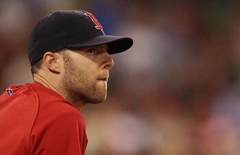 BOSTON - JULY 15:  Dustin Pedroia #15 of the Boston Red Sox watches the game from the dugout in the ninth inning against the Texas Rangers on July 15, 2010 at Fenway Park in Boston, Massachusetts. The Rangers defeated the Red Sox 7-2.  (Photo by Elsa/Gett
