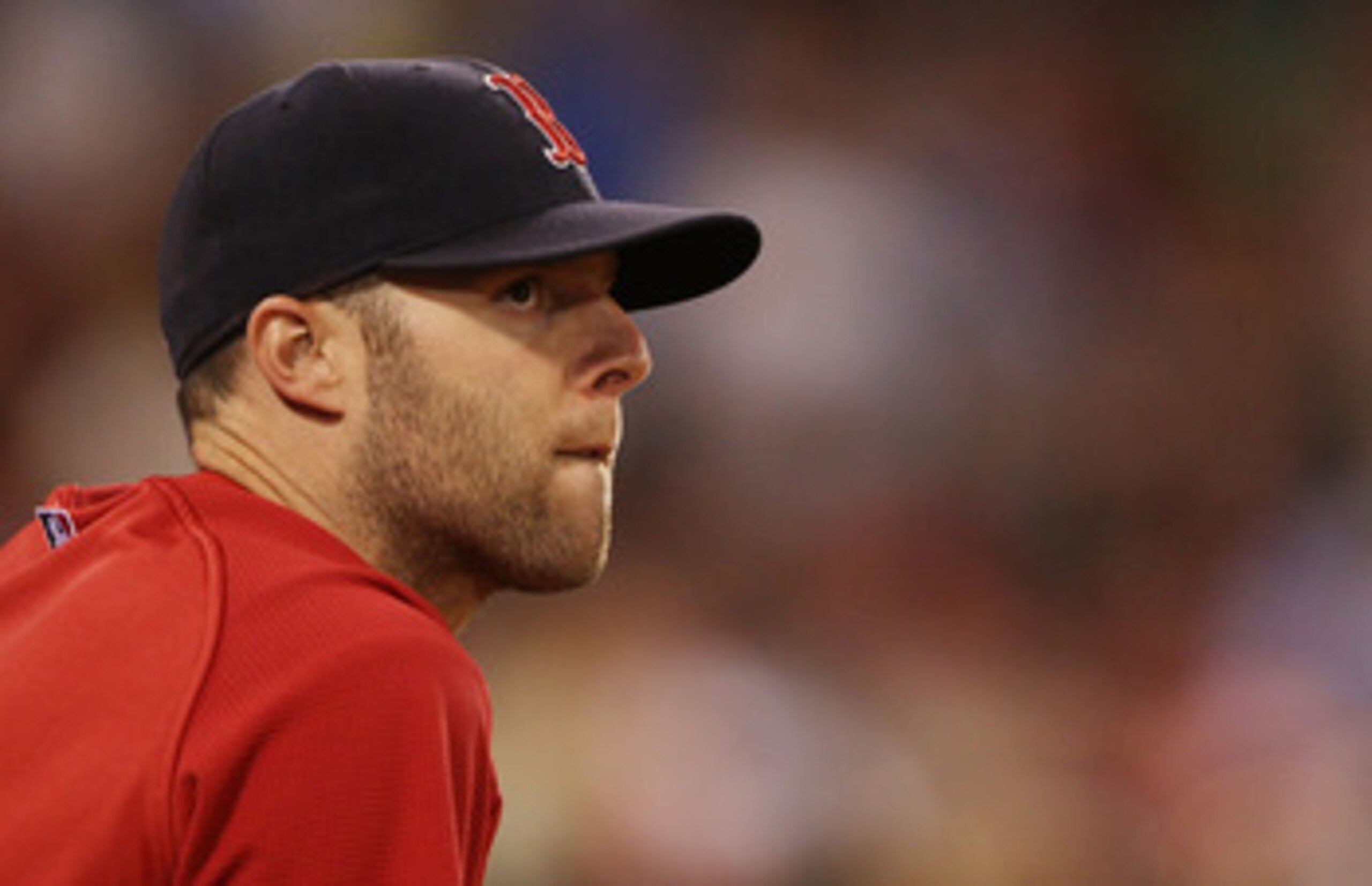 BOSTON - JULY 15:  Dustin Pedroia #15 of the Boston Red Sox watches the game from the dugout in the ninth inning against the Texas Rangers on July 15, 2010 at Fenway Park in Boston, Massachusetts. The Rangers defeated the Red Sox 7-2.  (Photo by Elsa/Gett