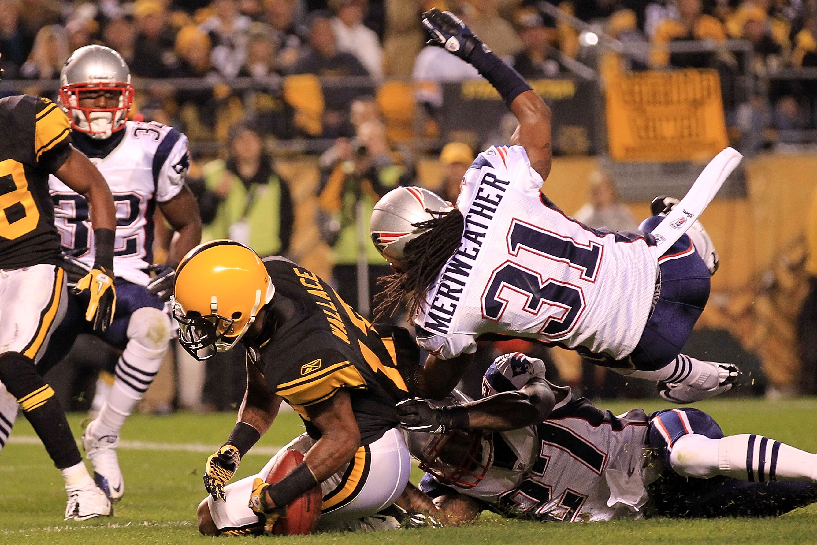 PITTSBURGH - NOVEMBER 14:  Mike Wallace #17 of the Pittsburgh Steelers drops the ball in the endzone under pressure from Brandon Meriweather #31 and Kyle Arrington #27 of the New England Patriots on November 14, 2010 at Heinz Field in Pittsburgh, Pennsylv