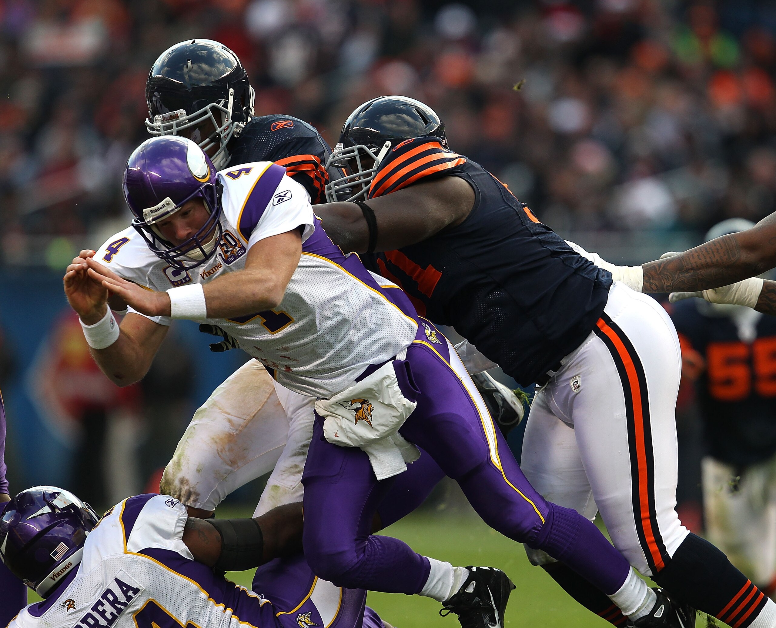 CHICAGO - NOVEMBER 14: Julius Peppers #90 (L) and Israel Idonije #71 of the Chicago Bears knock down Brett Favre #4 of the Minnesota Vikings after a pass at Soldier Field on November 14, 2010 in Chicago, Illinois. The Bears defeated the Vikings 27-13. (Ph CHICAGO - NOVEMBER 14: Julius Peppers #90 (L) and Israel Idonije #71 of the Chicago Bears knock down Brett Favre #4 of the Minnesota Vikings after a pass at Soldier Field on November 14, 2010 in Chicago, Illinois. The Bears defeated the Vikings 27-13. (Ph