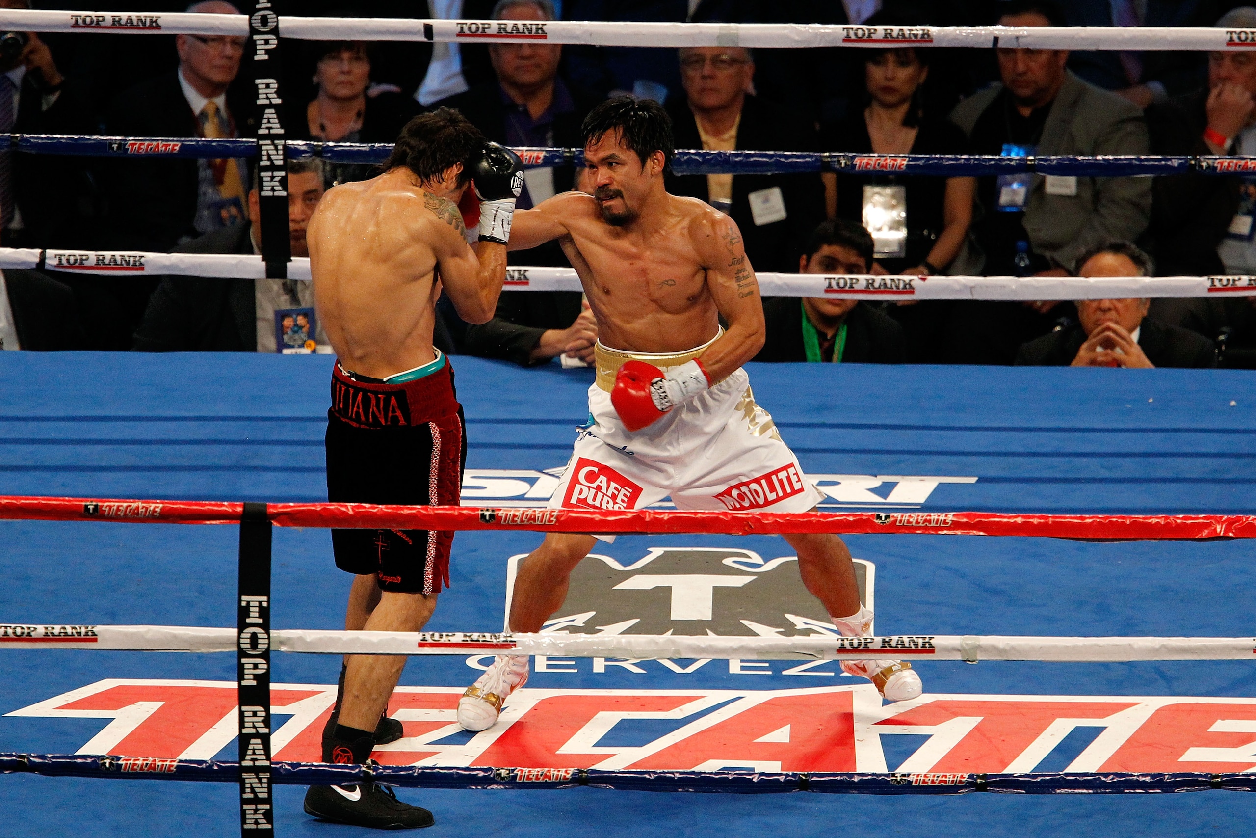 ARLINGTON, TX - NOVEMBER 13: Manny Pacquiao (white trunks) of the Philippines fights against Antonio Margarito (black trunks) of Mexico during their WBC World Super Welterweight Title bout at Cowboys Stadium on November 13, 2010 in Arlington, Texas. (Ph ARLINGTON, TX - NOVEMBER 13: Manny Pacquiao (white trunks) of the Philippines fights against Antonio Margarito (black trunks) of Mexico during their WBC World Super Welterweight Title bout at Cowboys Stadium on November 13, 2010 in Arlington, Texas. (Ph