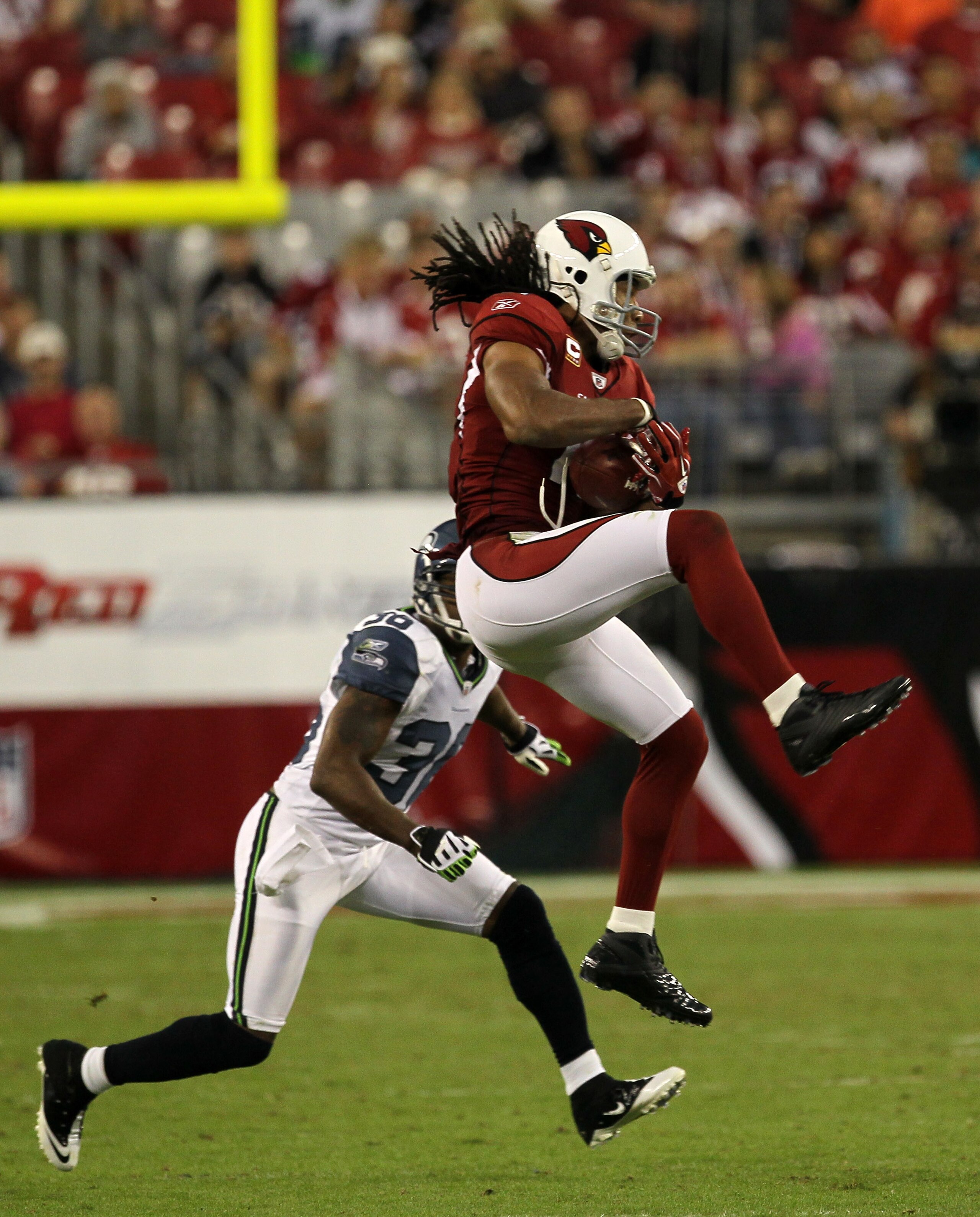 GLENDALE, AZ - NOVEMBER 14: Wide receiver Larry Fitzgerald #11 of the Arizona Cardinals makes a catch in front of safety Lawyer Milloy #36 of the Seattle Seahawks at University of Phoenix Stadium on November 14, 2010 in Glendale, Arizona. Seattle won 36- GLENDALE, AZ - NOVEMBER 14: Wide receiver Larry Fitzgerald #11 of the Arizona Cardinals makes a catch in front of safety Lawyer Milloy #36 of the Seattle Seahawks at University of Phoenix Stadium on November 14, 2010 in Glendale, Arizona. Seattle won 36-