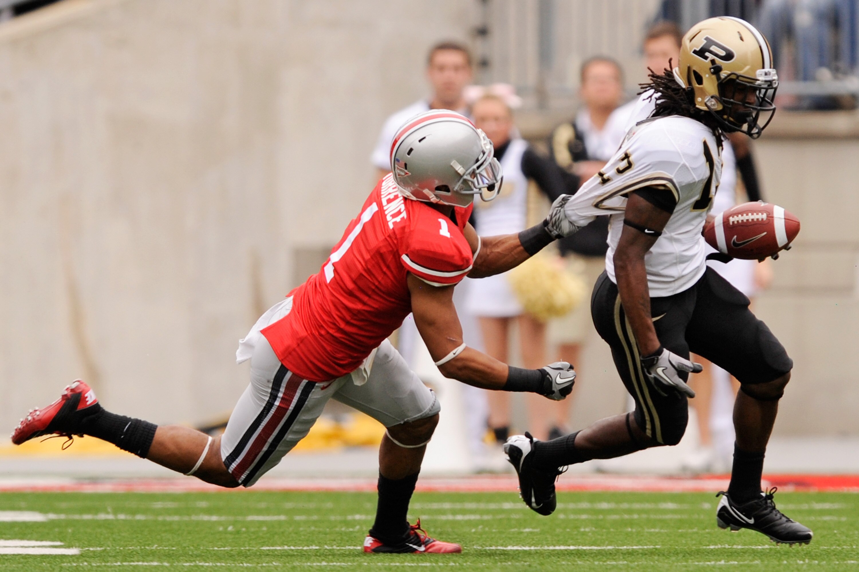 COLUMBUS, OH - OCTOBER 23:  Devon Torrence #1 of the Ohio State Buckeyes hauls down Antavian Edison #13 of the Purdue Boilermakers by his shirt at Ohio Stadium on October 23, 2010 in Columbus, Ohio.  (Photo by Jamie Sabau/Getty Images)