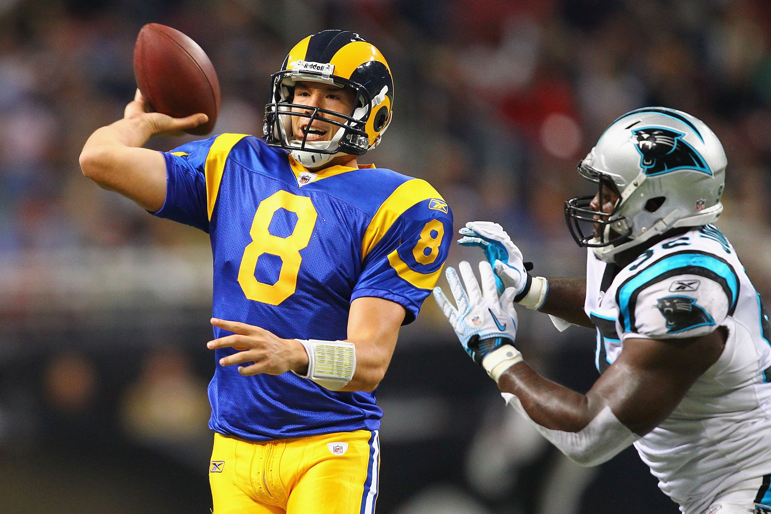 ST. LOUIS - OCTOBER 31: Sam Bradford #8 of the St. Louis Rams looks to pass against Eric Norwood #92 of the Carolina Panthers at the Edward Jones Dome on October 31, 2010 in St. Louis, Missouri.  The Rams beat the Panthers 20-10.  (Photo by Dilip Vishwana