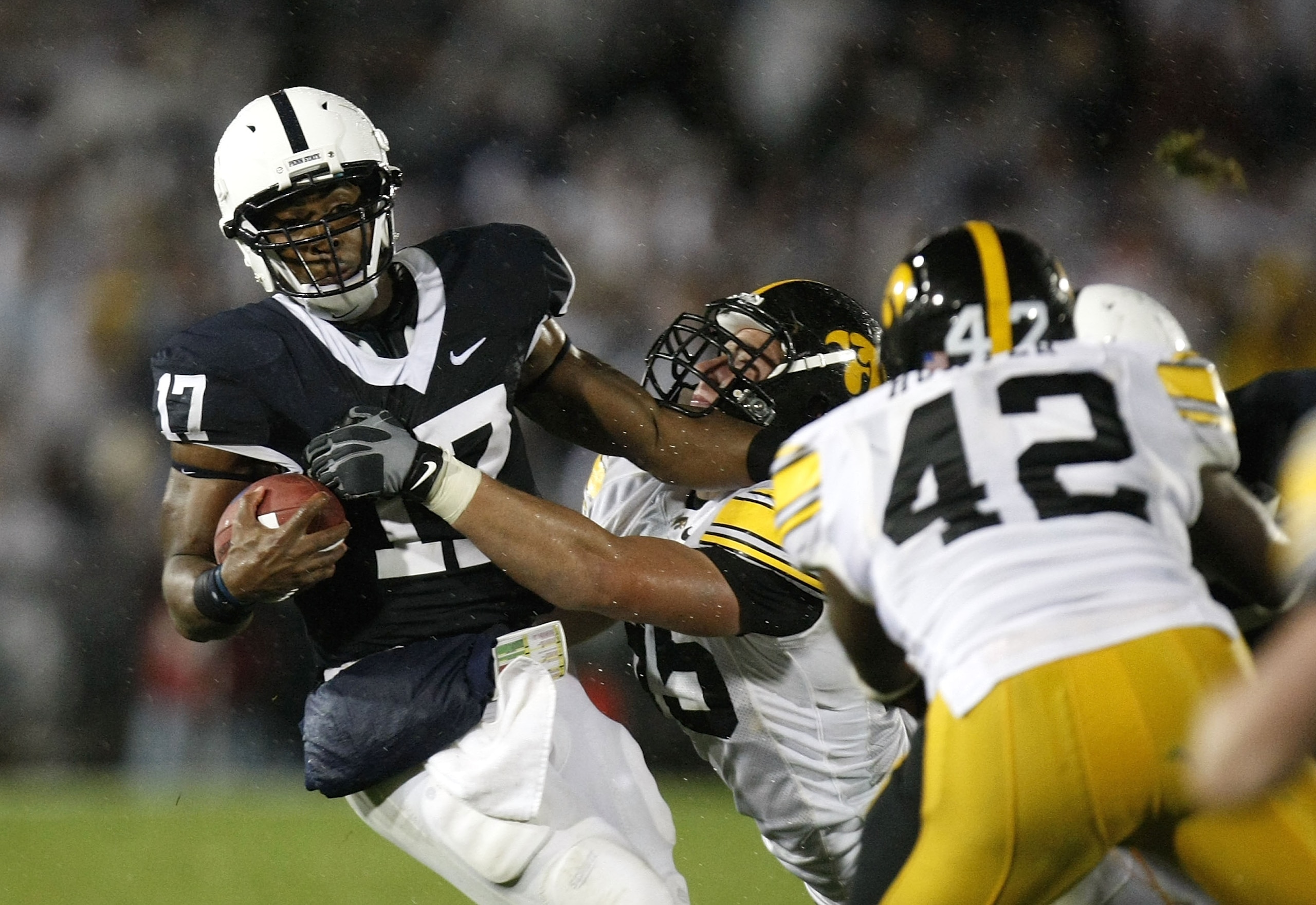 STATE COLLEGE, PA - SEPTEMBER 26: Daryll Clark #17 of the Penn State Nittnay Lions is tackled by Karl Klug #95 and Jeremiha Hunter #42 of the Iowa Hawkeye's on September 26, 2009 at Beaver Stadium in State College, Pennsylvania. (Photo by Gregory Shamus STATE COLLEGE, PA - SEPTEMBER 26: Daryll Clark #17 of the Penn State Nittnay Lions is tackled by Karl Klug #95 and Jeremiha Hunter #42 of the Iowa Hawkeye's on September 26, 2009 at Beaver Stadium in State College, Pennsylvania. (Photo by Gregory Shamus