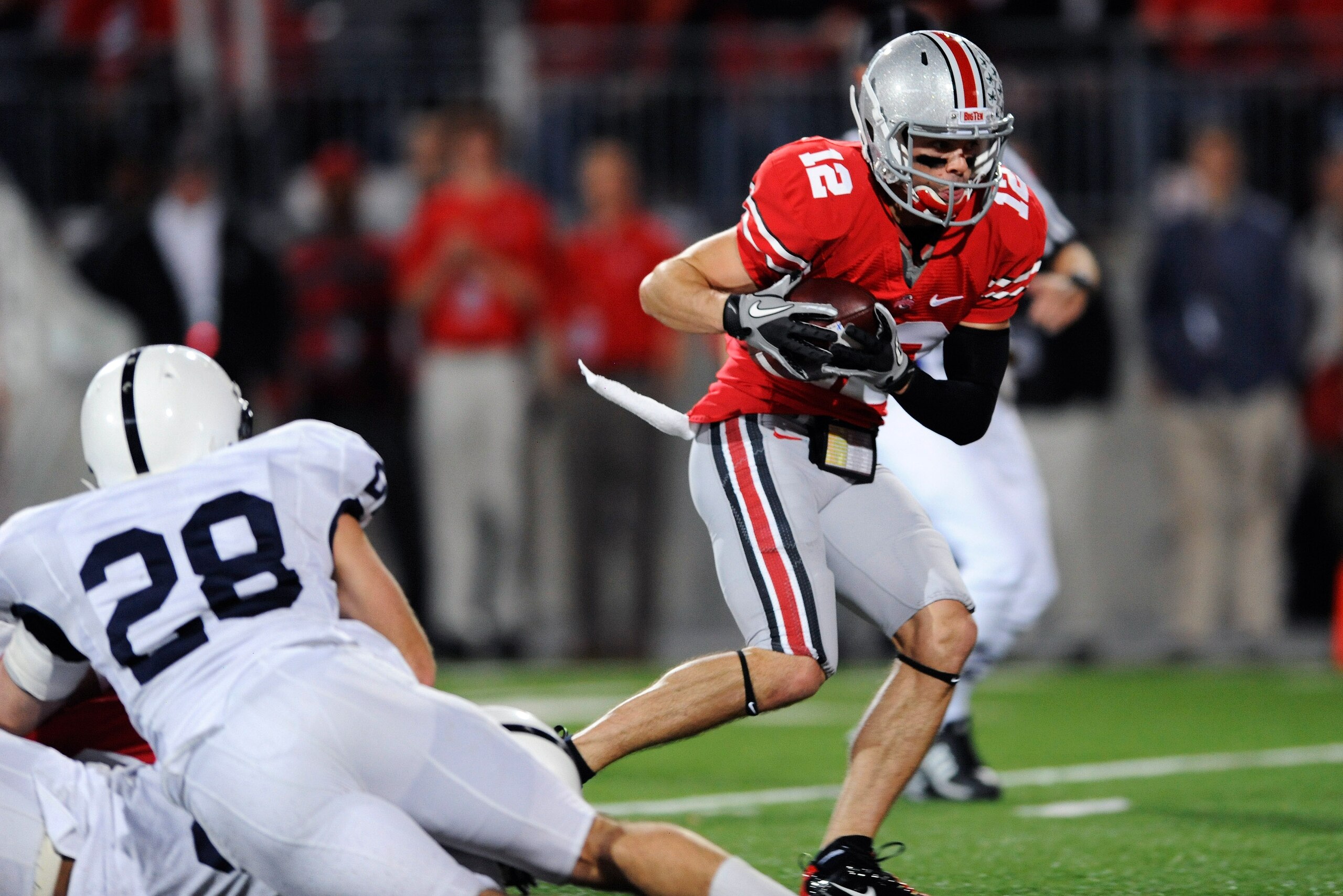 COLUMBUS, OH - NOVEMBER 13: Dane Sanzenbacher #12 of the Ohio State Buckeyes makes the reception for a 58-yard touchdown after the ball bounced off teammate DeVier Posey #8 of the Ohio State Buckeyes in the third quarter against the Penn State Nittany Li COLUMBUS, OH - NOVEMBER 13: Dane Sanzenbacher #12 of the Ohio State Buckeyes makes the reception for a 58-yard touchdown after the ball bounced off teammate DeVier Posey #8 of the Ohio State Buckeyes in the third quarter against the Penn State Nittany Li