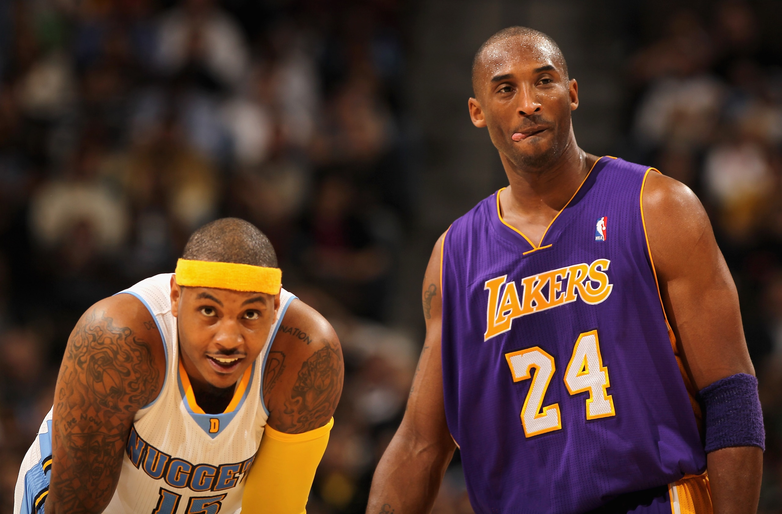 DENVER - NOVEMBER 11:  Kobe Bryant #24 of the Los Angeles Lakers and Carmelo Anthony #15 of the Denver Nuggets look on during a break in the action at the Pepsi Center on November 11, 2010 in Denver, Colorado. The Nuggets defeated the Lakers 118-112.  NOT