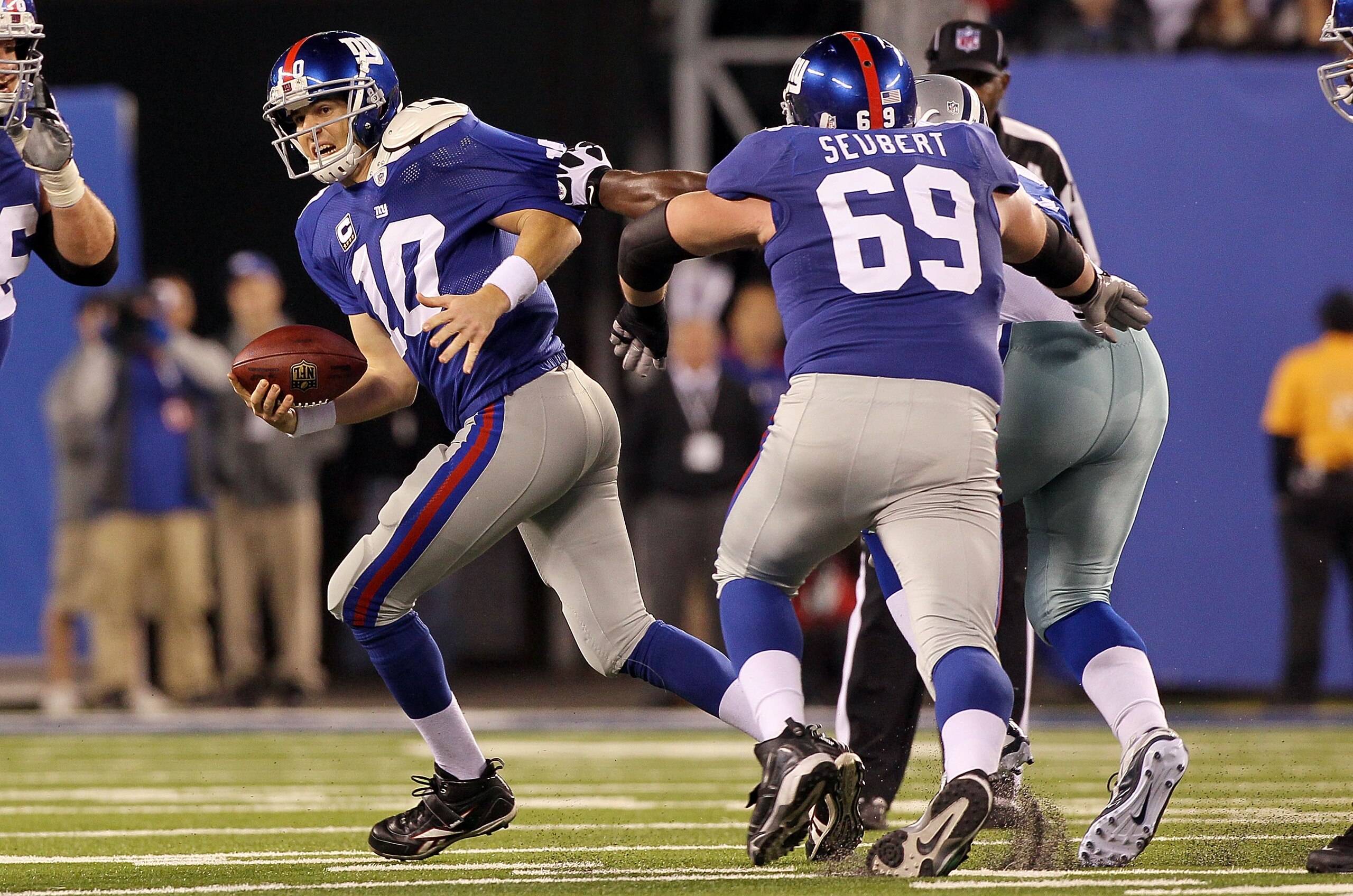 EAST RUTHERFORD, NJ - NOVEMBER 14: Eli Manning #10 of the New York Giants tries to run the ball against the Dallas Cowboys on November 14, 2010 at the New Meadowlands Stadium in East Rutherford, New Jersey. The Cowboys defeated the Giants 33-20. (Photo EAST RUTHERFORD, NJ - NOVEMBER 14: Eli Manning #10 of the New York Giants tries to run the ball against the Dallas Cowboys on November 14, 2010 at the New Meadowlands Stadium in East Rutherford, New Jersey. The Cowboys defeated the Giants 33-20. (Photo