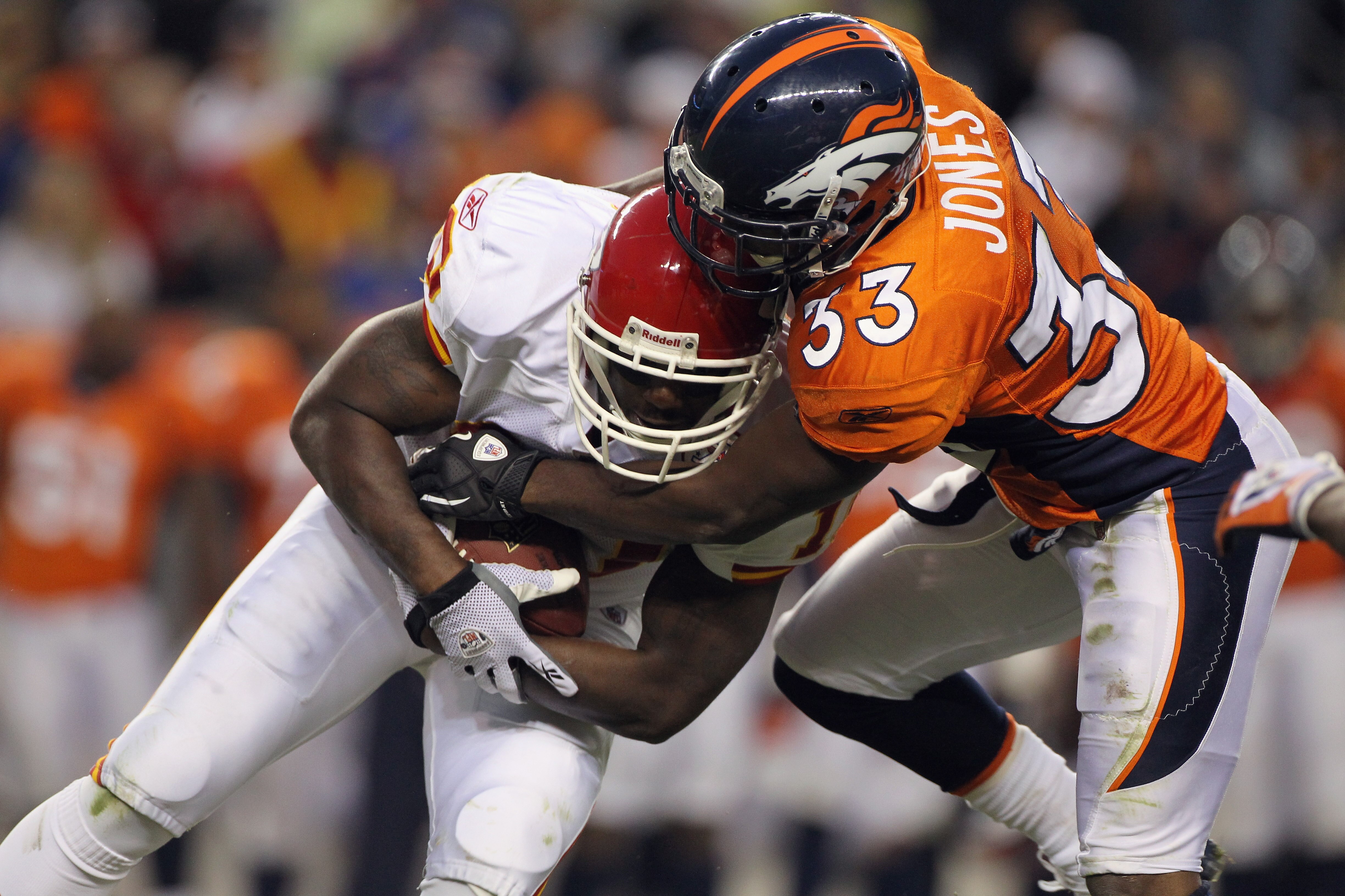DENVER - NOVEMBER 14:  Wide receiver Terrance Copper #10 of the Kansas City Chiefs makes a reception and is stopped by corner back Nate Jones #33 of the Denver Bronco at INVESCO Field at Mile High on November 14, 2010 in Denver, Colorado. The Broncos defe