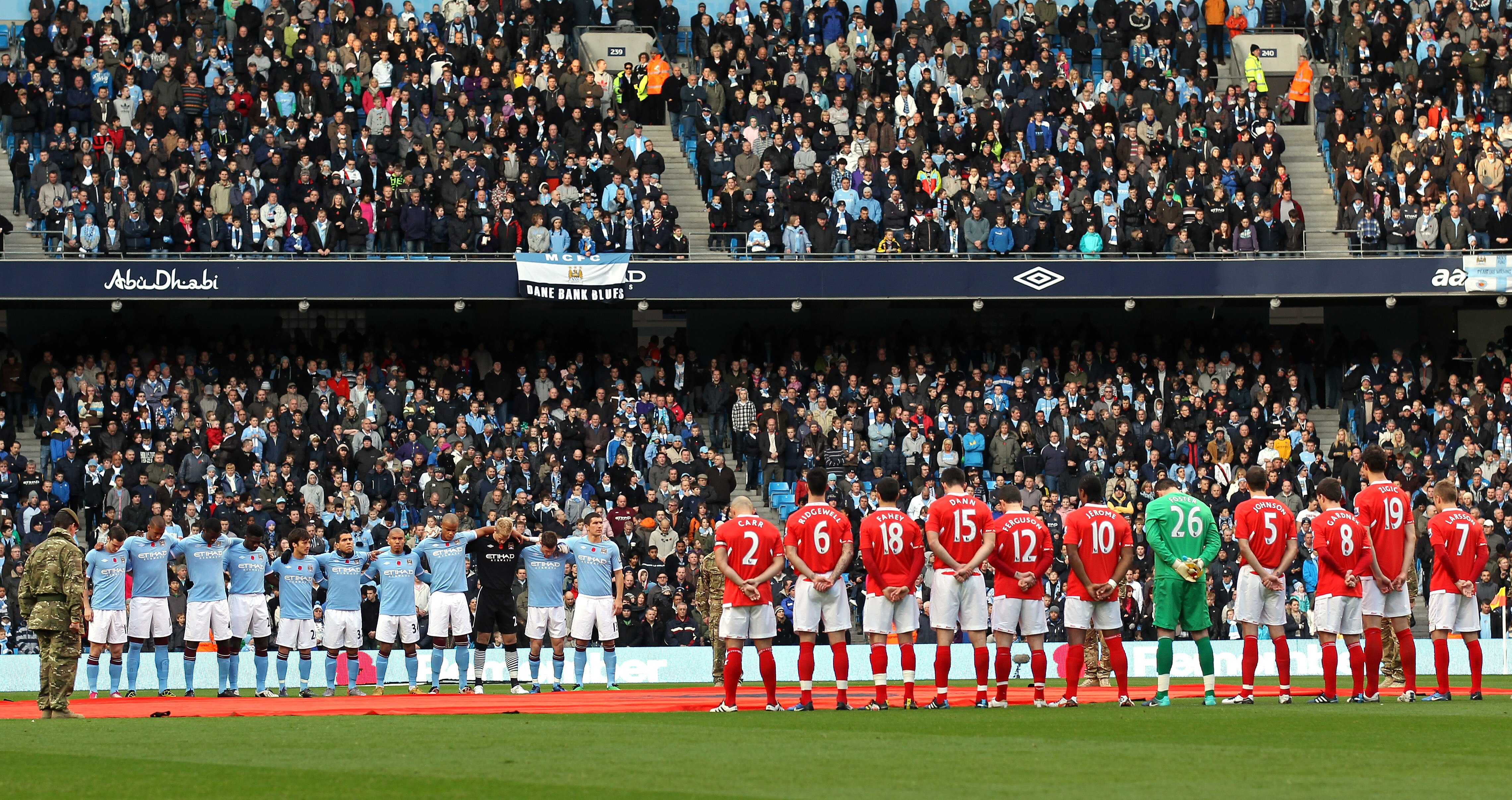 MANCHESTER, ENGLAND - NOVEMBER 13:  The players of Manchester City and Birmingham City stand for a one minutes silence before the Barclays Premier League match between Manchester City and Birmingham City at City of Manchester Stadium on November 13, 2010 