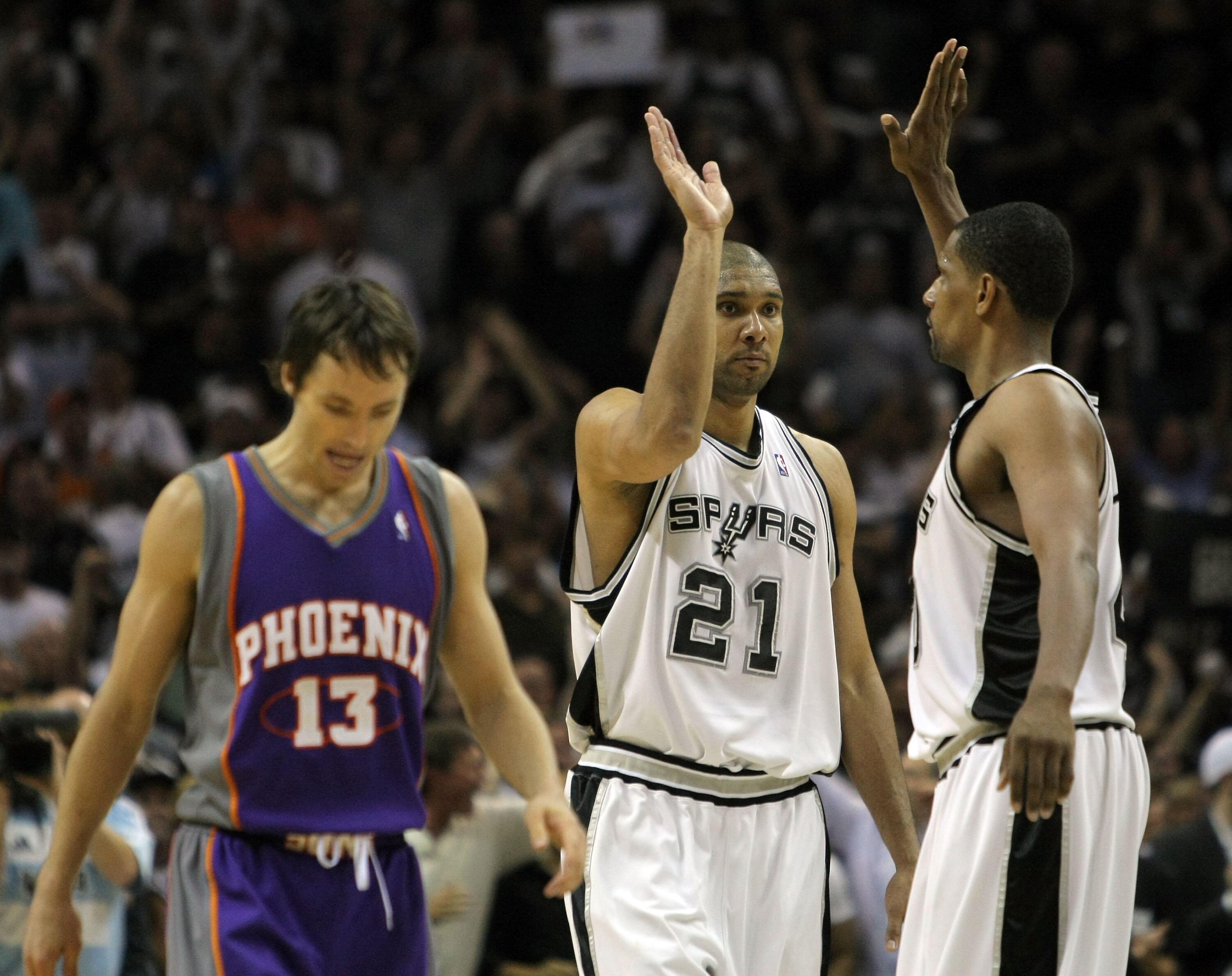 SAN ANTONIO - APRIL 29:  Tim Duncan #21 of the San Antonio Spurs celebrates in the final seconds with teammate Kurt Thomas #40 in front of Steve Nash #13 of the Phoenix Suns on way to a 92-87 win and a 4-1 series win in Game Five of the Western Conference