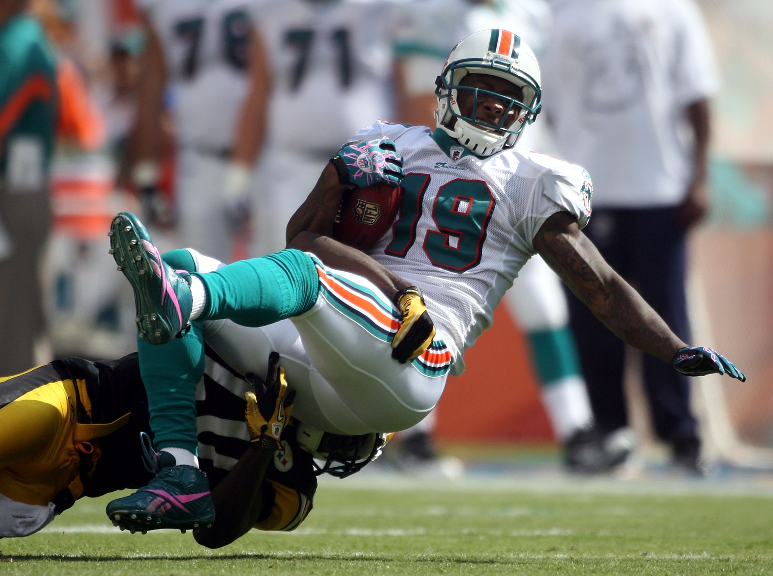 MIAMI - OCTOBER 24:  Receiver Brandon Marshall #19 is brought down by the Pittsburgh Steelers  at Sun Life Stadium on October 24, 2010 in Miami, Florida.  (Photo by Marc Serota/Getty Images)