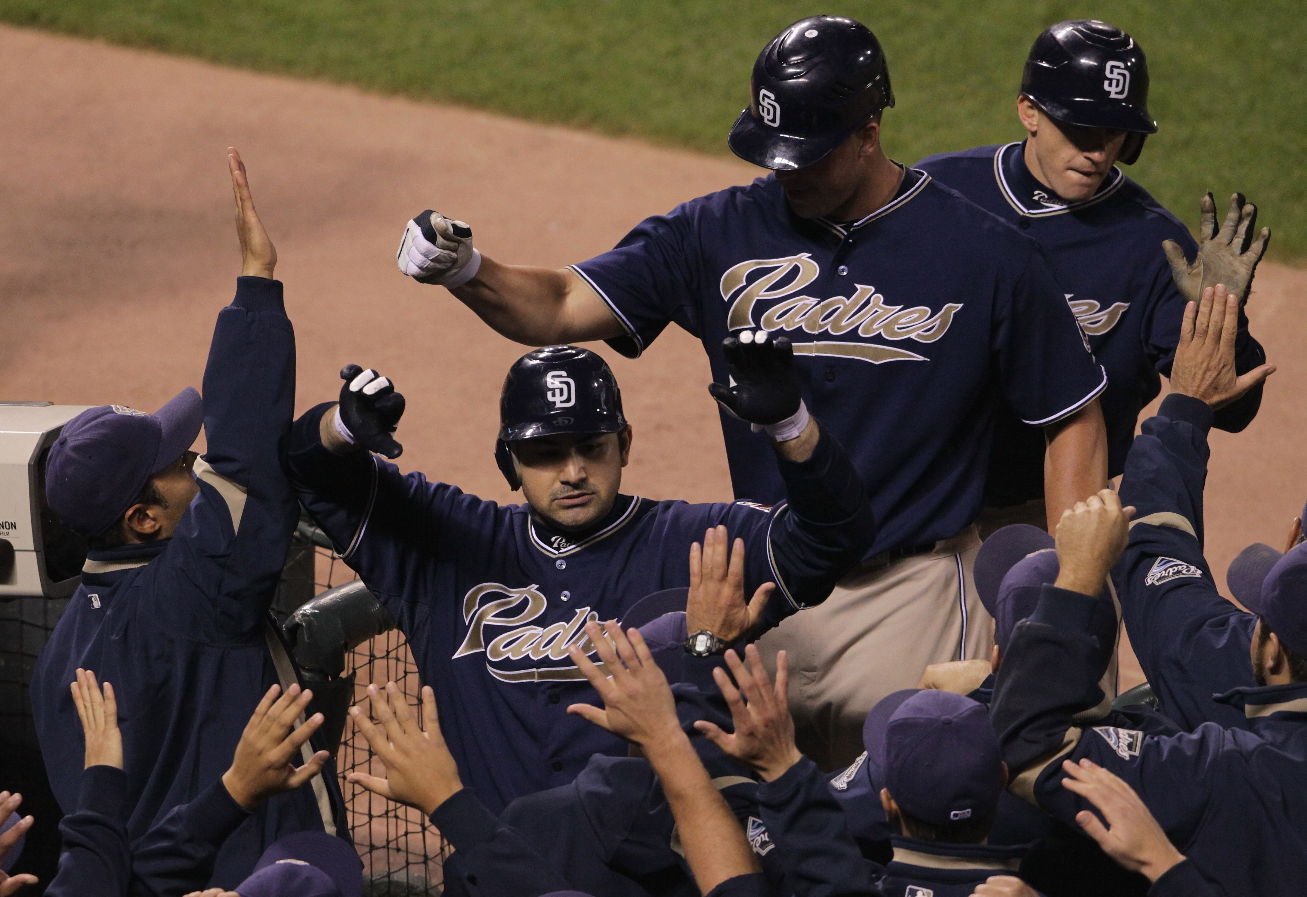 SAN FRANCISCO - OCTOBER 01:  Adrian Gonzalez #23 of the San Diego Padres is congratulated by teammates after hitting a three run home run during the third inning against the San Francisco Giants October 1, 2010 in San Francisco, California.  (Photo by Jus