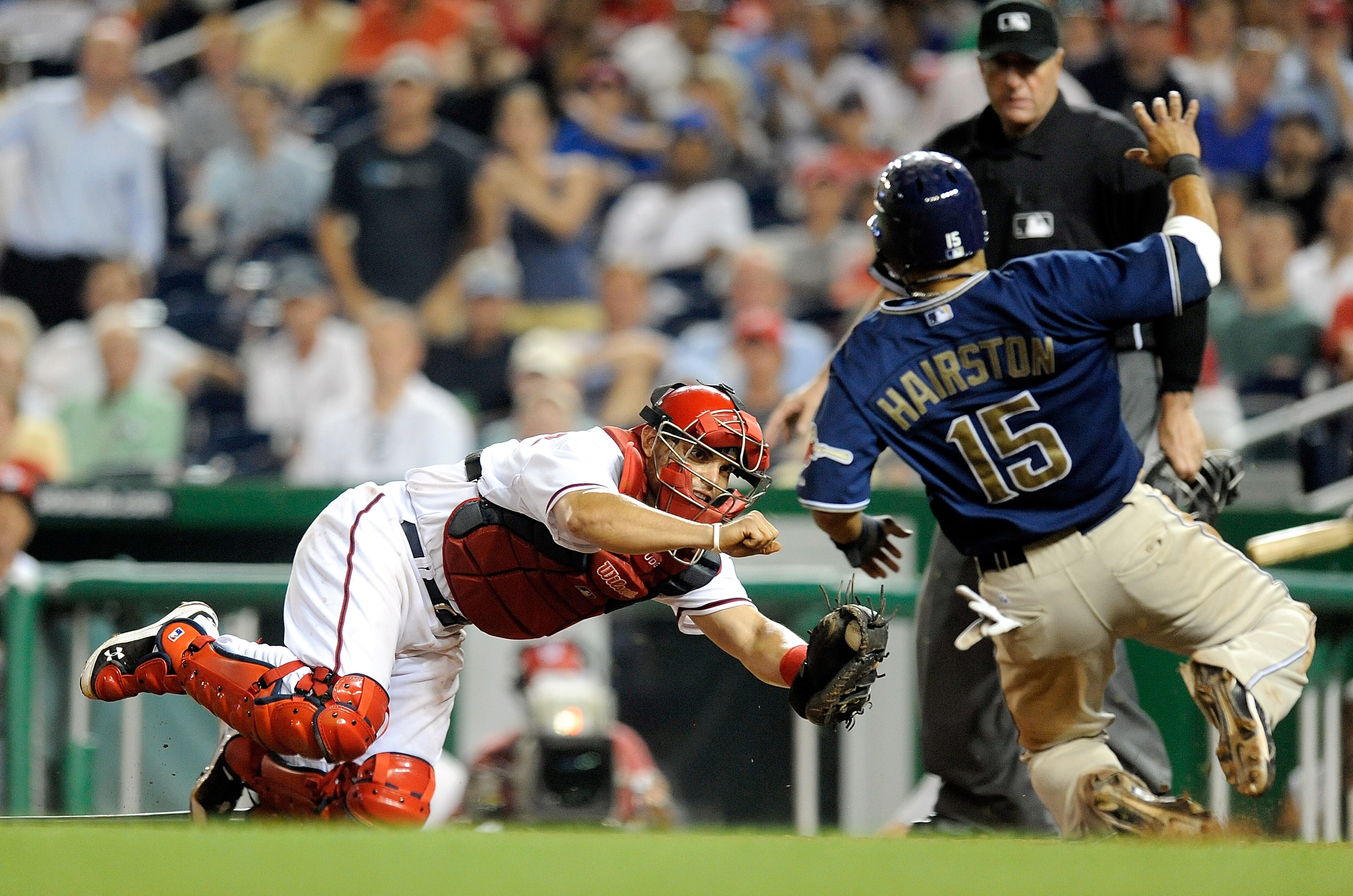 WASHINGTON - JULY 06:  Jerry Hairston Jr. #15 of the San Diego Padres is tagged out at home plate to end the ninth inning by Ivan Rodriguez #7 of the Washington Nationals at Nationals Park on July 6, 2010 in Washington, DC.  (Photo by Greg Fiume/Getty Ima
