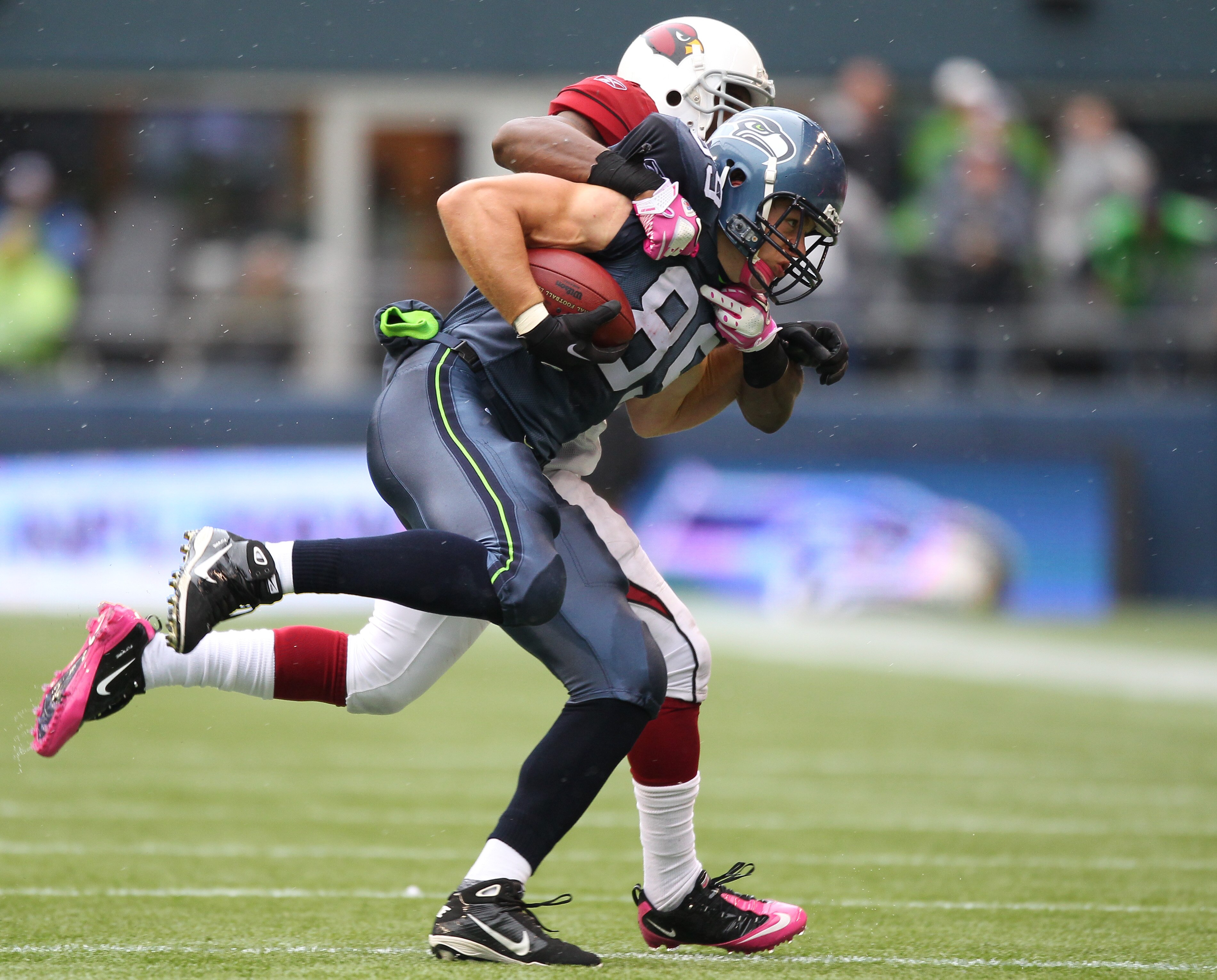 SEATTLE - OCTOBER 24:  Tight end John Carlson #89 of the Seattle Seahawks is driven out of bounds by linebacker Daryl Washington #58 of the Arizona Cardinals at Qwest Field on October 24, 2010 in Seattle, Washington. (Photo by Otto Greule Jr/Getty Images)