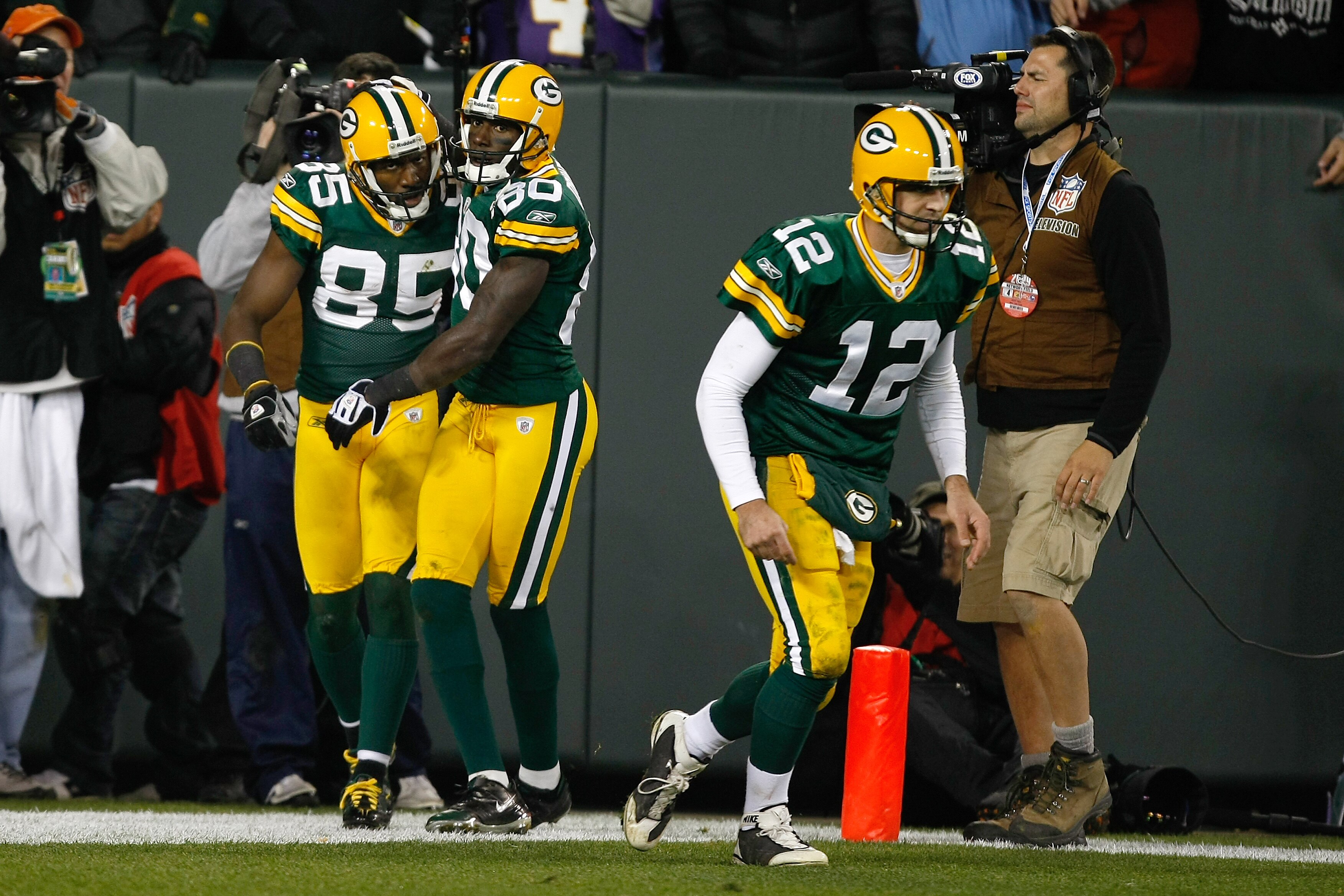 GREEN BAY, WI - NOVEMBER 1:  Wide receivers Donald Driver #80, Greg Jennings and quarterback Aaron Rogers #12 of the Green Bay Packers celebrate after a touchdown against the Minnesota Vikings at Lambeau Field on November 1, 2009 in Green Bay, Wisconsin.