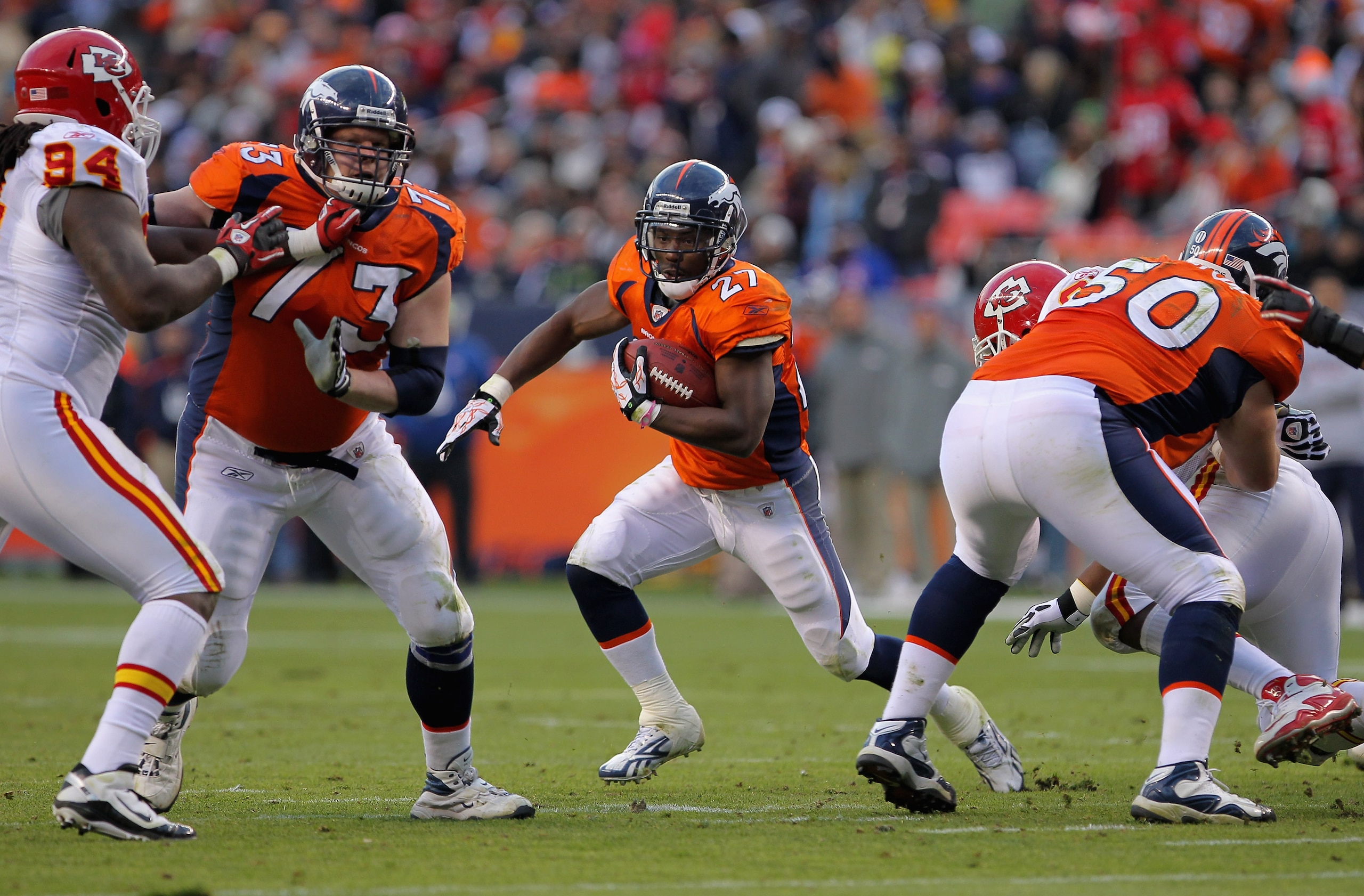 DENVER - NOVEMBER 14:  Running back Knowshon Moreno #27 of the Denver Broncos rushes between the blocks of Chris Kuper #73 and JD Walton #50 against the Kansas City Chiefs at INVESCO Field at Mile High on November 14, 2010 in Denver, Colorado. The Broncos