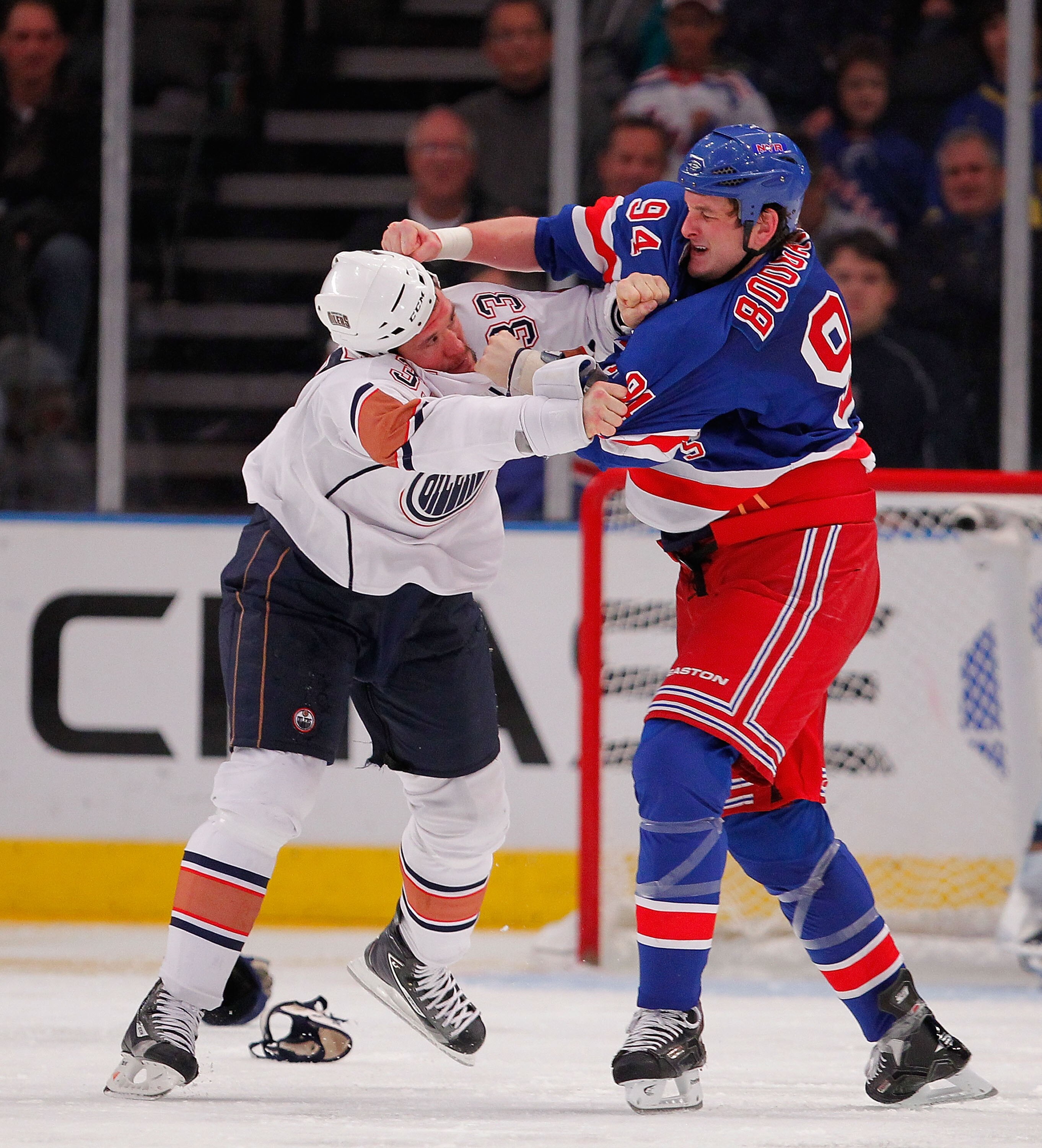 NEW YORK - NOVEMBER 14:  Steve MacIntyre #33 of the Edmonton Oilers fighting with Derek Boogaard #94 of the New York Rangers during a hockey game at Madison Square Garden on November 14, 2010 in New York City.  (Photo by Paul Bereswill/Getty Images)