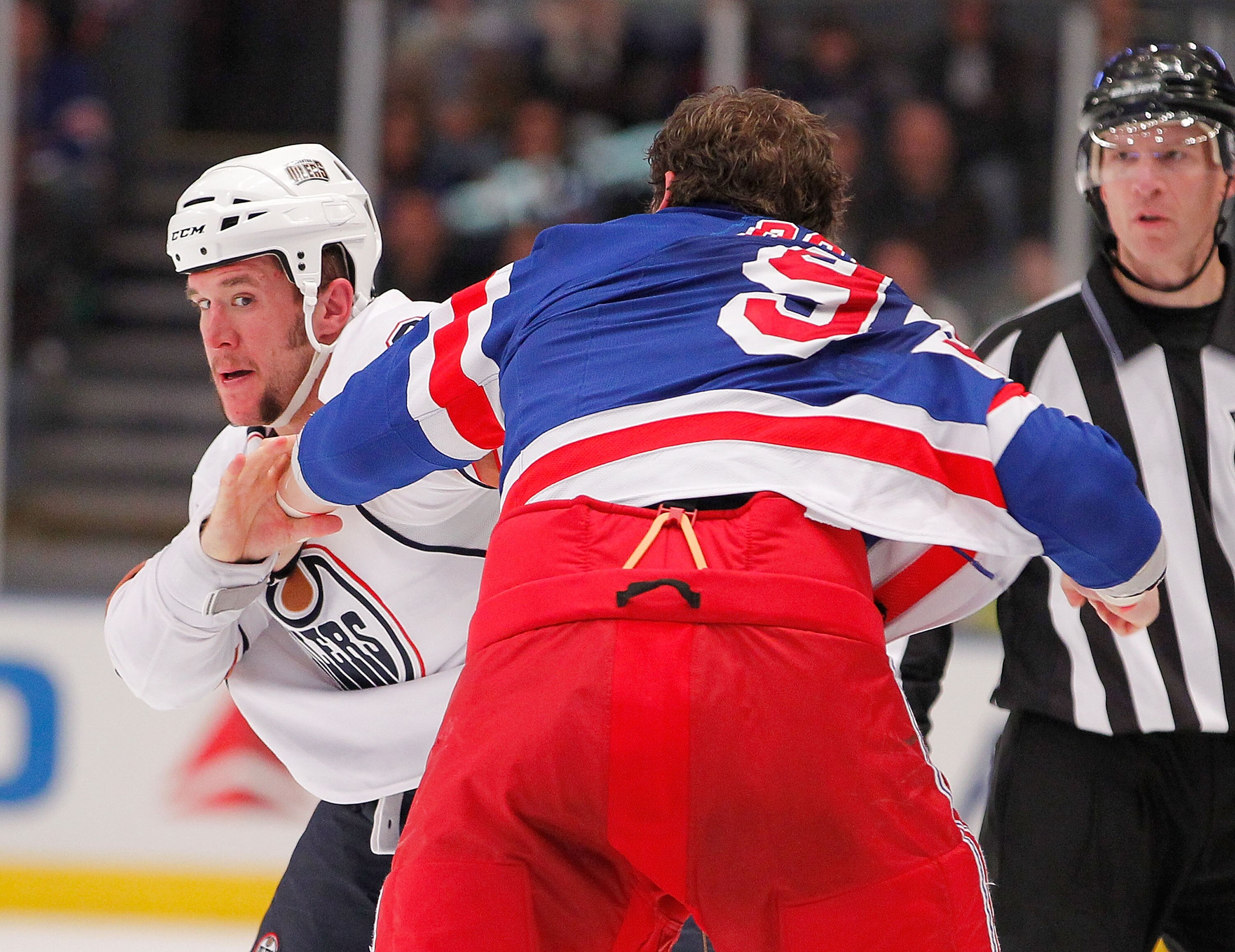NEW YORK - NOVEMBER 14:  Steve MacIntyre #33 of the Edmonton Oilers fighting with Derek Boogaard #94 of the New York Rangers during a hockey game at Madison Square Garden on November 14, 2010 in New York City.  (Photo by Paul Bereswill/Getty Images)