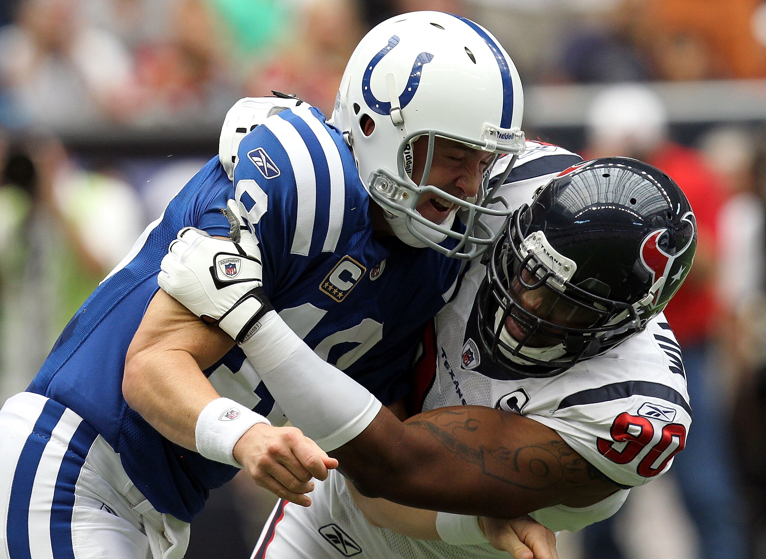 HOUSTON - SEPTEMBER 12: Quarterback Peyton Manning #18 of the Indianapolis Colts is tackled by Mario Williams #90 of the Houston Texans during the NFL season opener at Reliant Stadium on September 12, 2010 in Houston, Texas. (Photo by Ronald Martinez/Ge HOUSTON - SEPTEMBER 12: Quarterback Peyton Manning #18 of the Indianapolis Colts is tackled by Mario Williams #90 of the Houston Texans during the NFL season opener at Reliant Stadium on September 12, 2010 in Houston, Texas. (Photo by Ronald Martinez/Ge