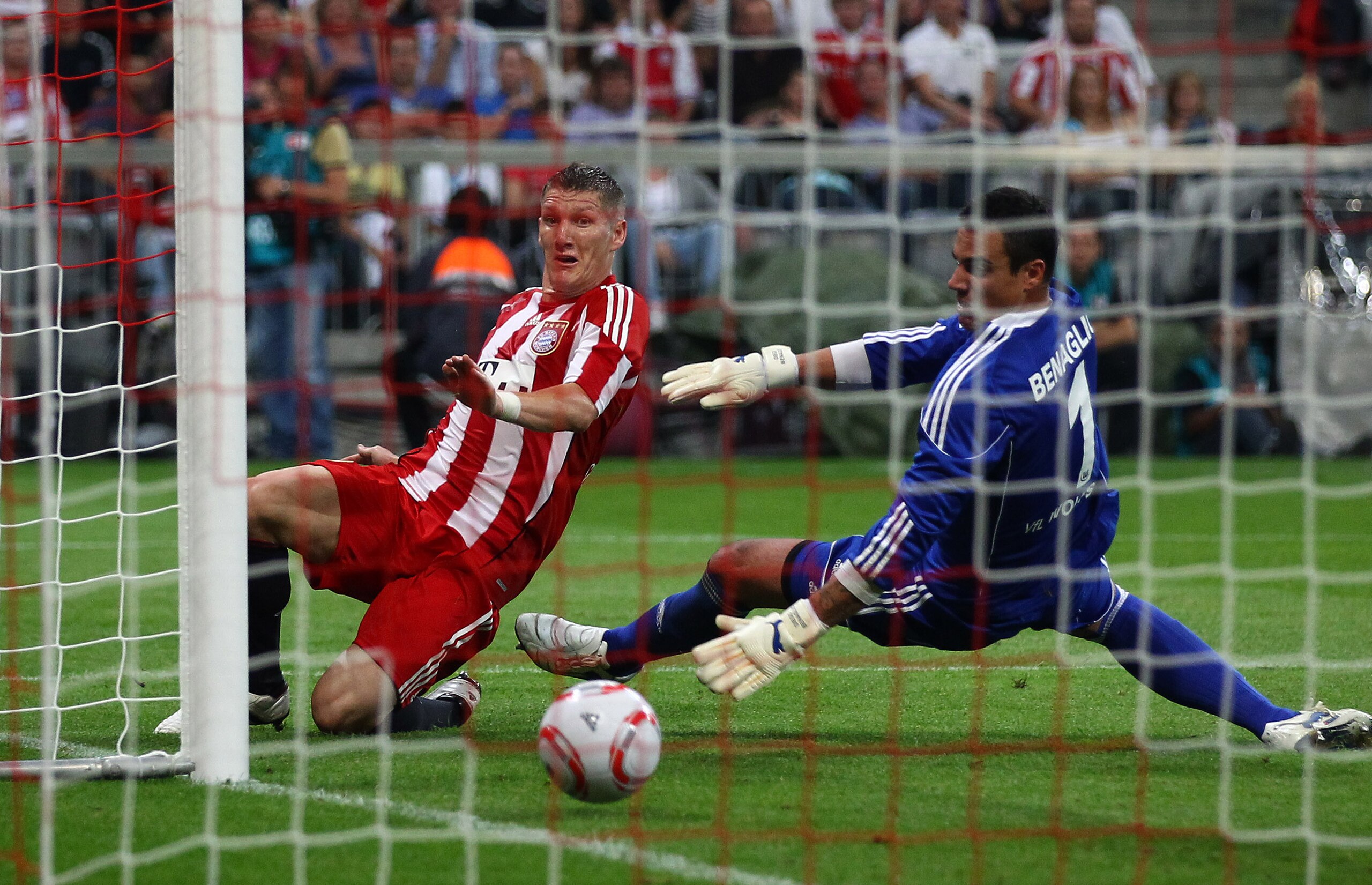 MUNICH, GERMANY - AUGUST 20: Bastian Schweinsteiger of Bayern scores his team's second and winning goal against goalkeeper Diego Benaglio of Wolfsburg during the Bundesliga match between FC Bayern Muenchen and VfL Wolfsburg at Allianz Arena on August 20, MUNICH, GERMANY - AUGUST 20: Bastian Schweinsteiger of Bayern scores his team's second and winning goal against goalkeeper Diego Benaglio of Wolfsburg during the Bundesliga match between FC Bayern Muenchen and VfL Wolfsburg at Allianz Arena on August 20,